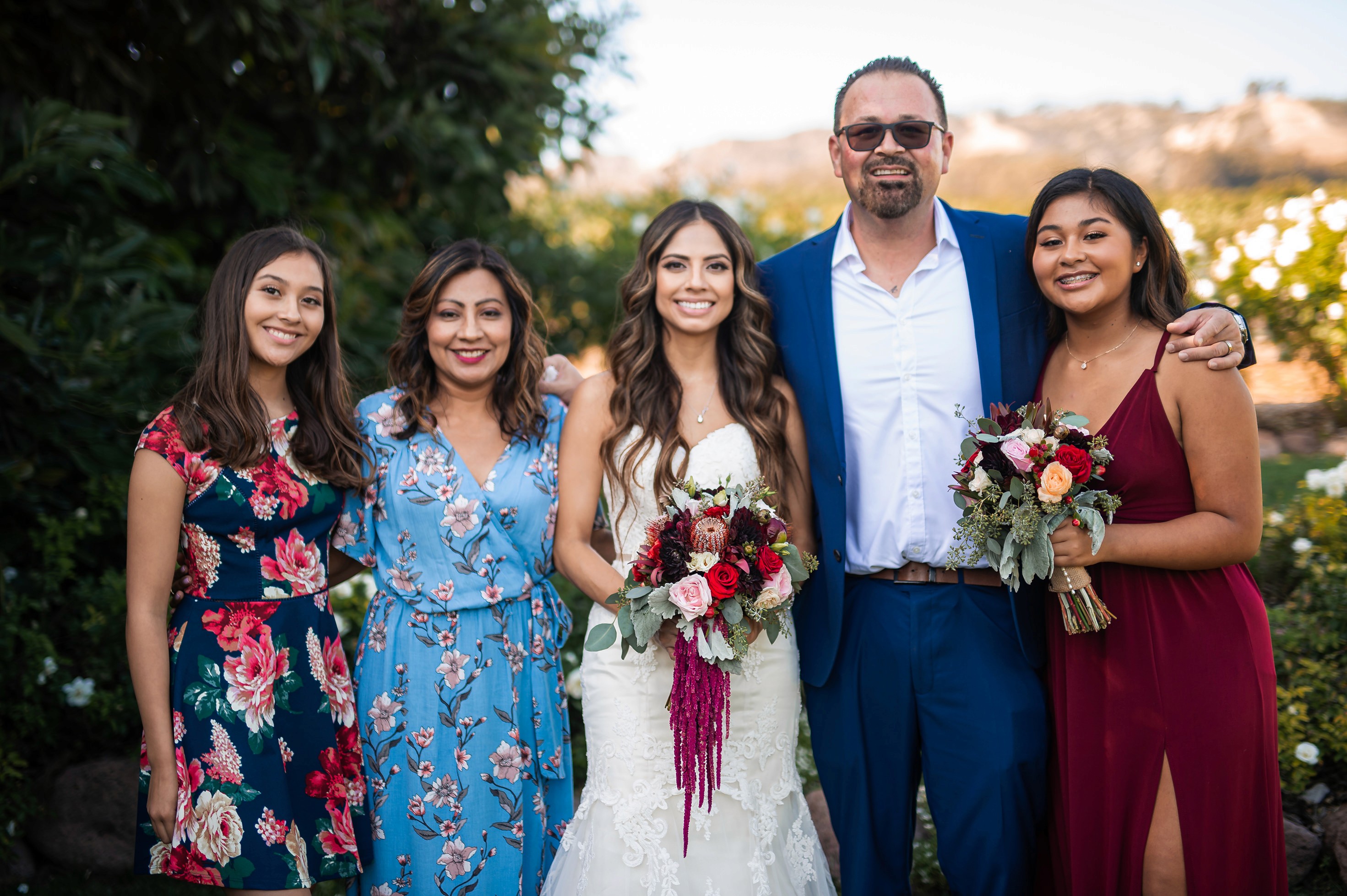 Flat lay wedding details with bouquet, rings, and sparkling bridal heels