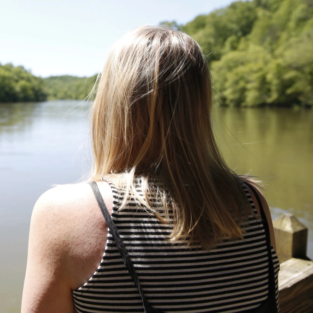 Woman viewing lake, picture from behind
