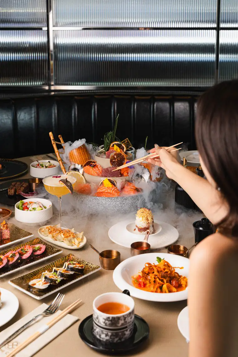 Guest enjoying a sashimi platter on smoking ice