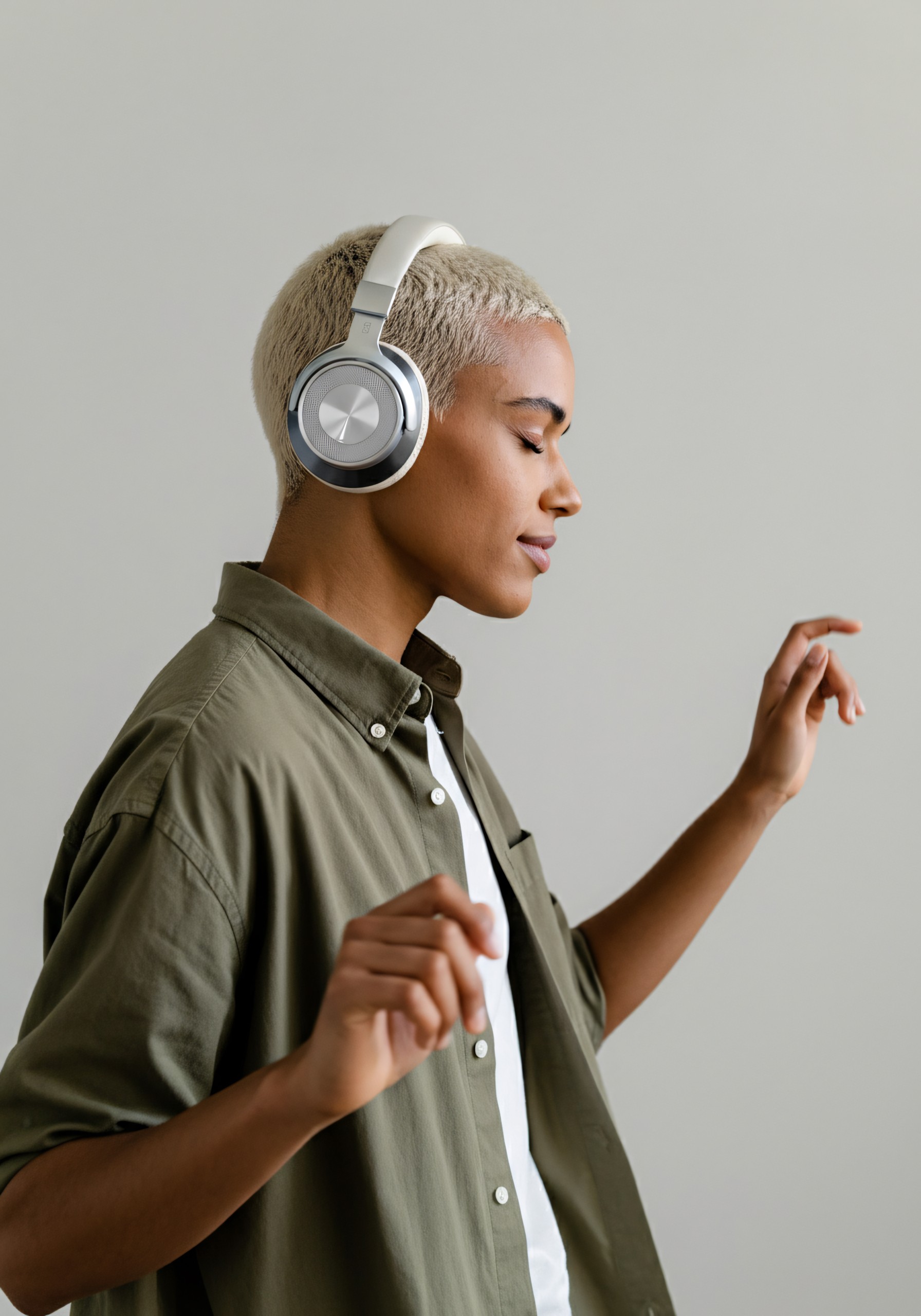 Man wearing silver headphones dancing.