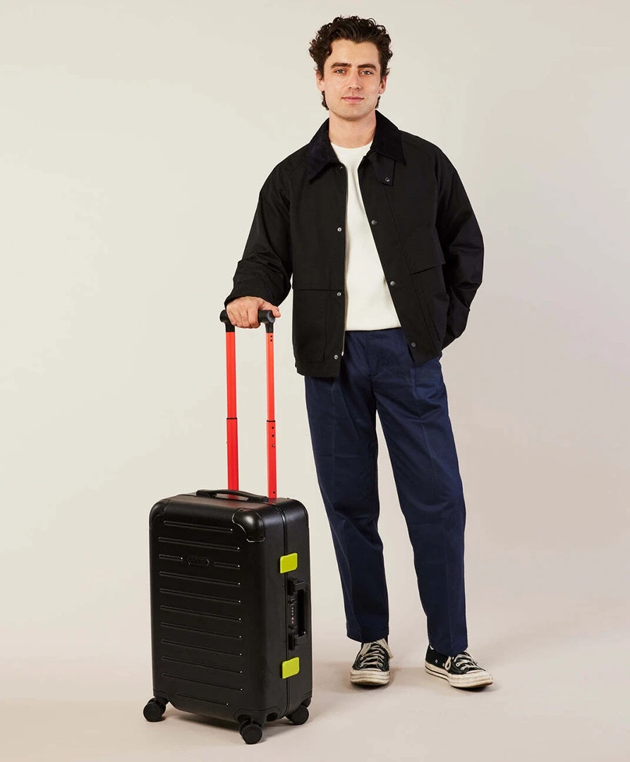 MoMA × Solgaard carry-on luggage shown in use to demonstrate scale and portability