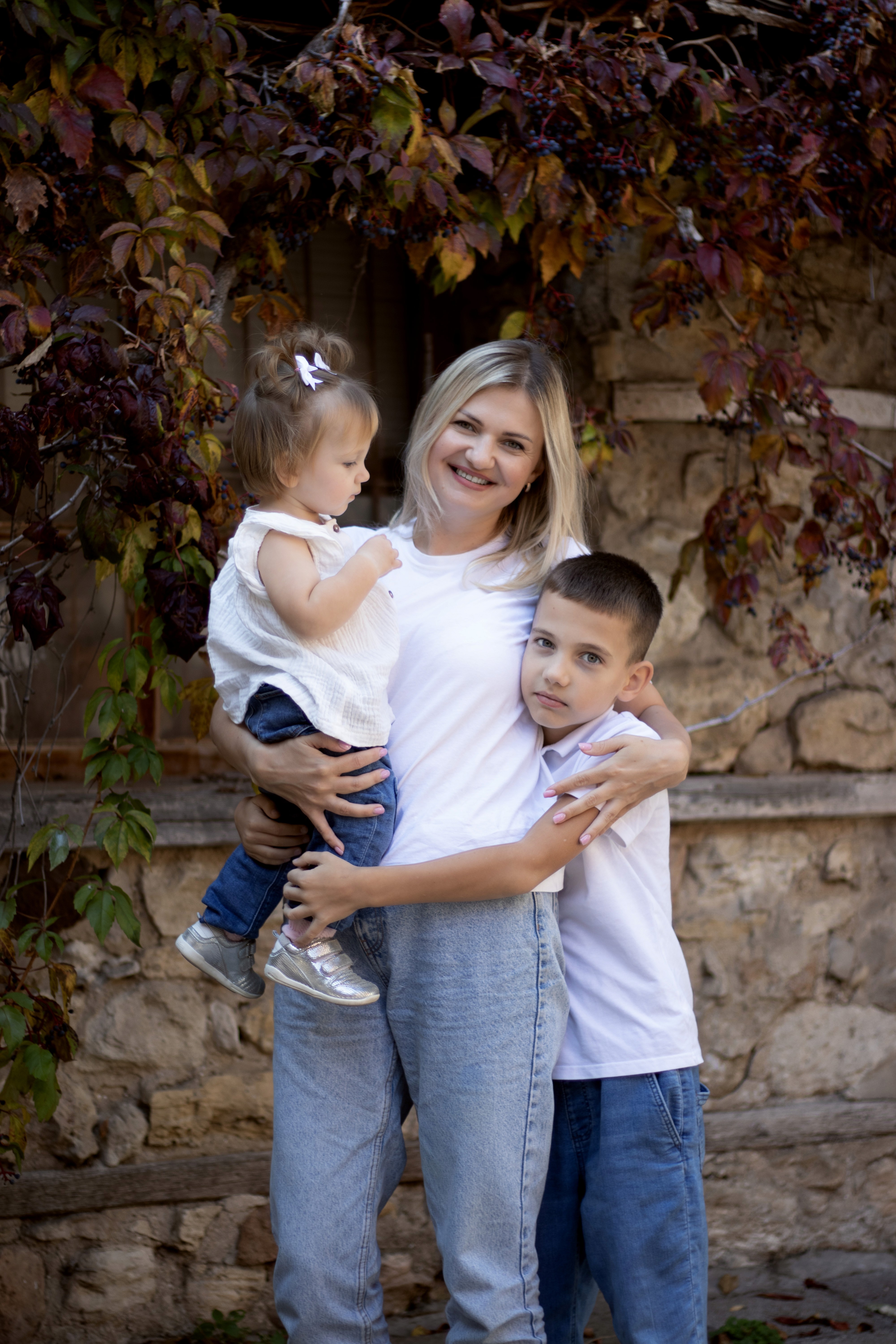 woman holding baby beside man smiling