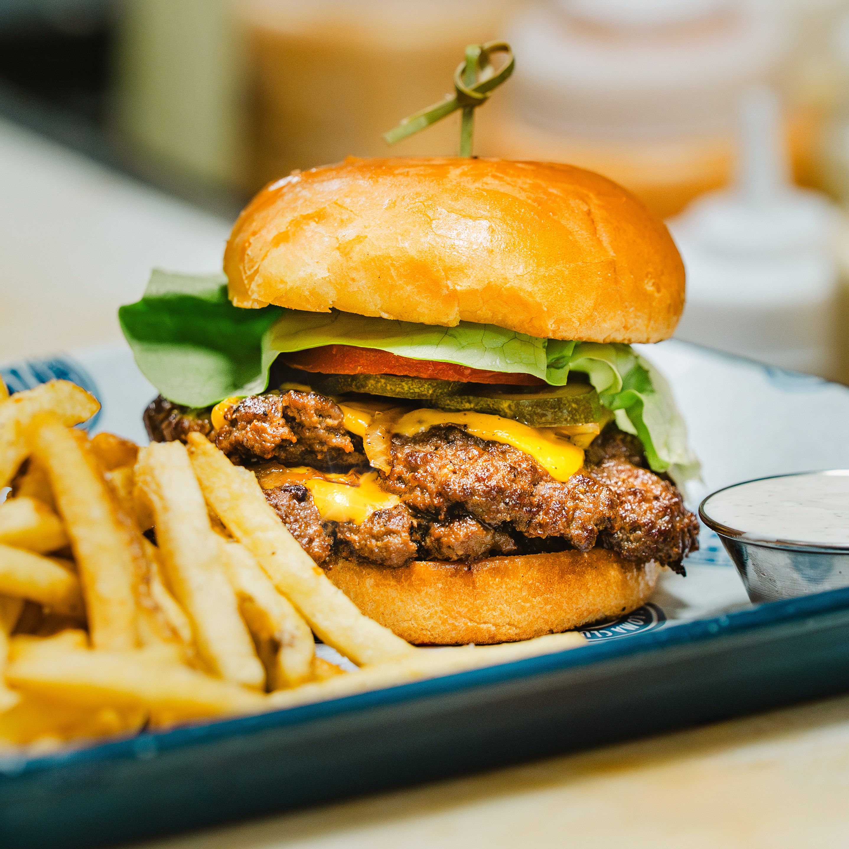 Black and white photo of two people looking at a computer screen with papers on wall