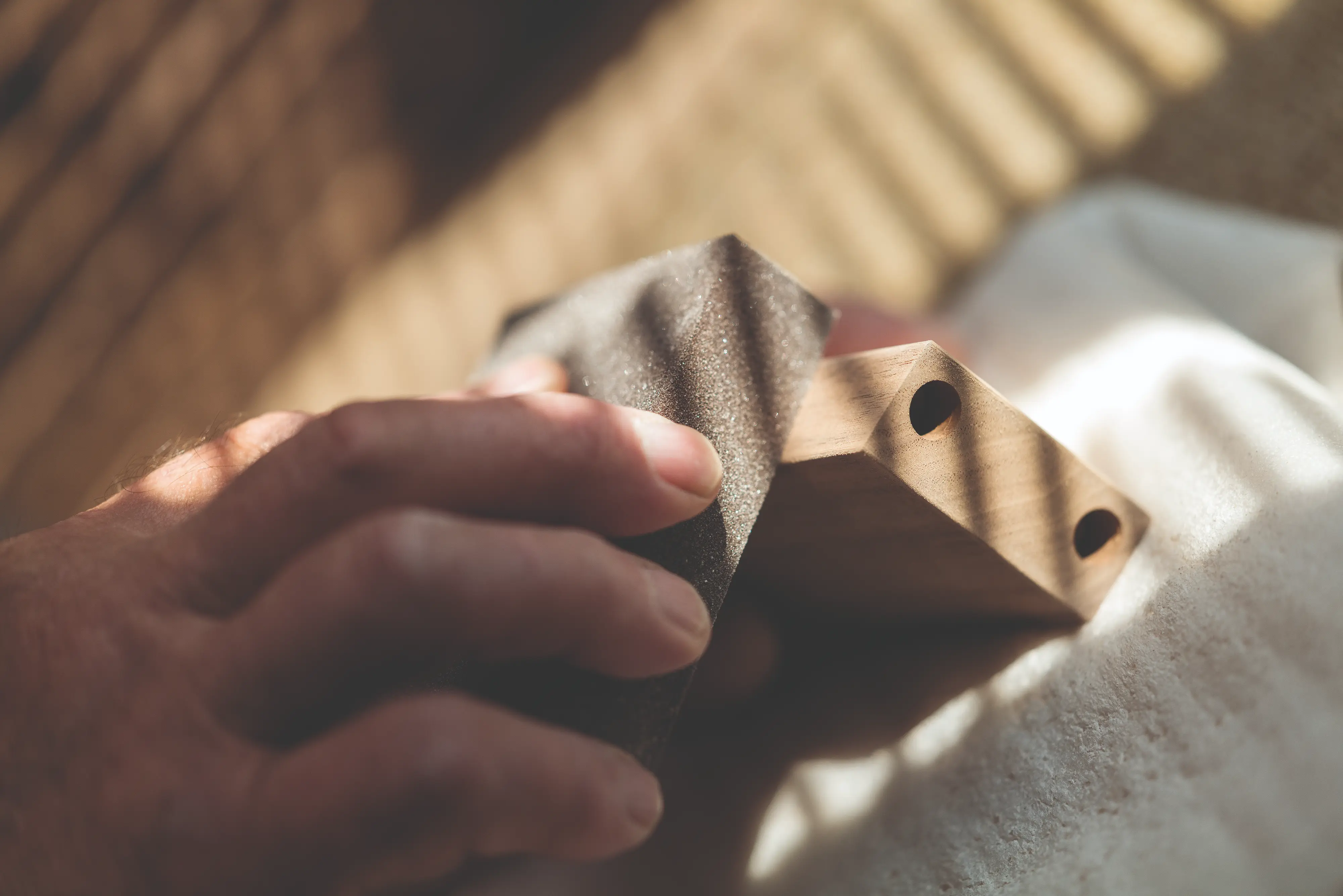 Handcrafting a HORL®3 oak wood magnetic angle support with precise hand-sanding in the German Black Forest workshop.