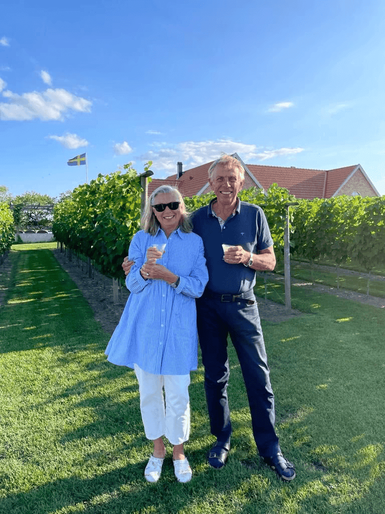 Guests laughing and savoring wine at Elara Vineyard House in Saros