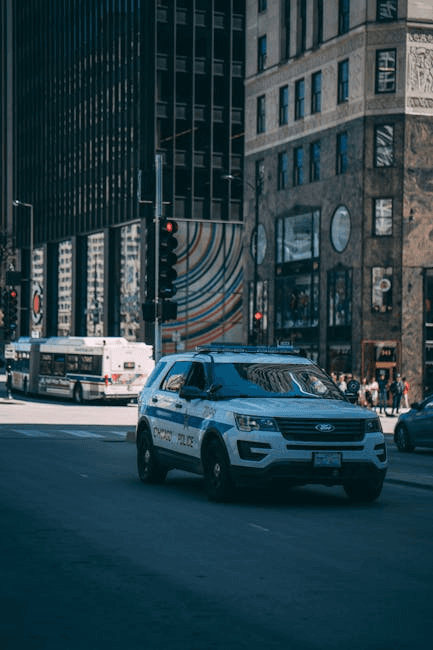 A Chicago police car navigating busy downtown streets during the day.