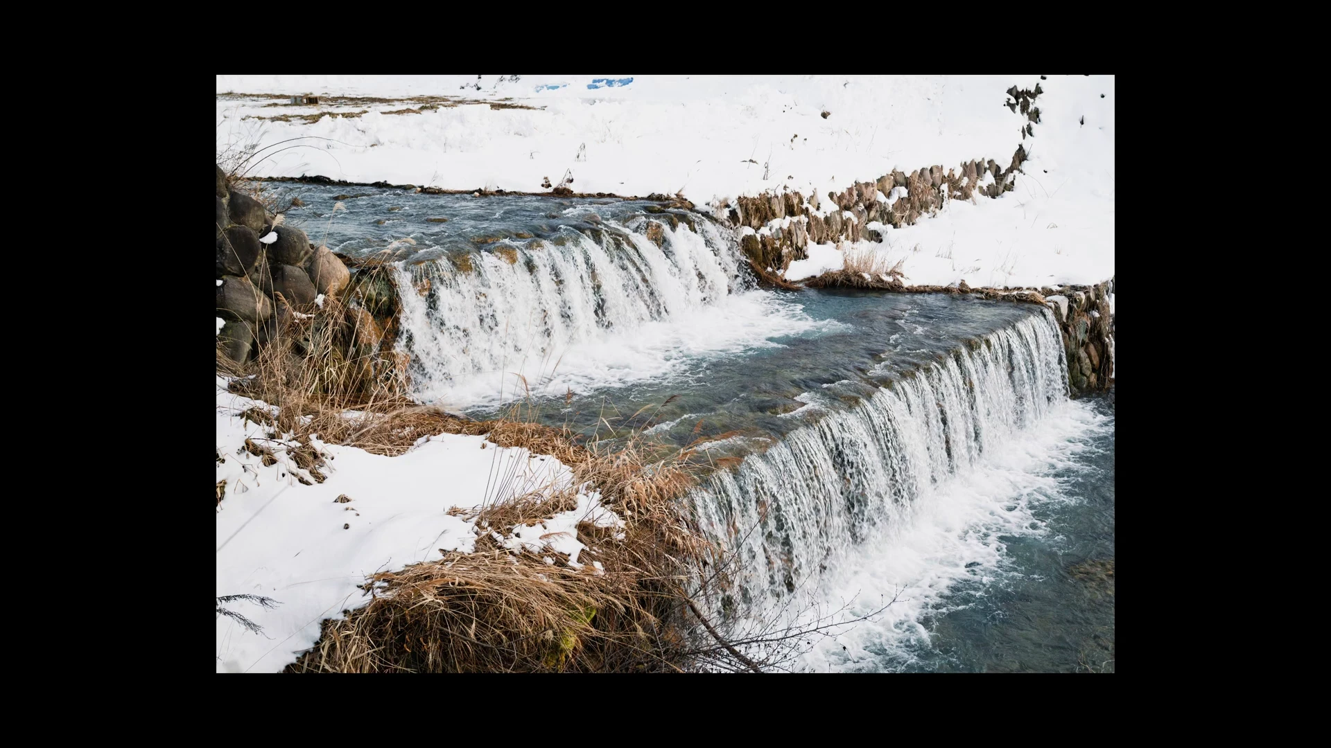 Onsen village along a river in the Nagano valley in winter