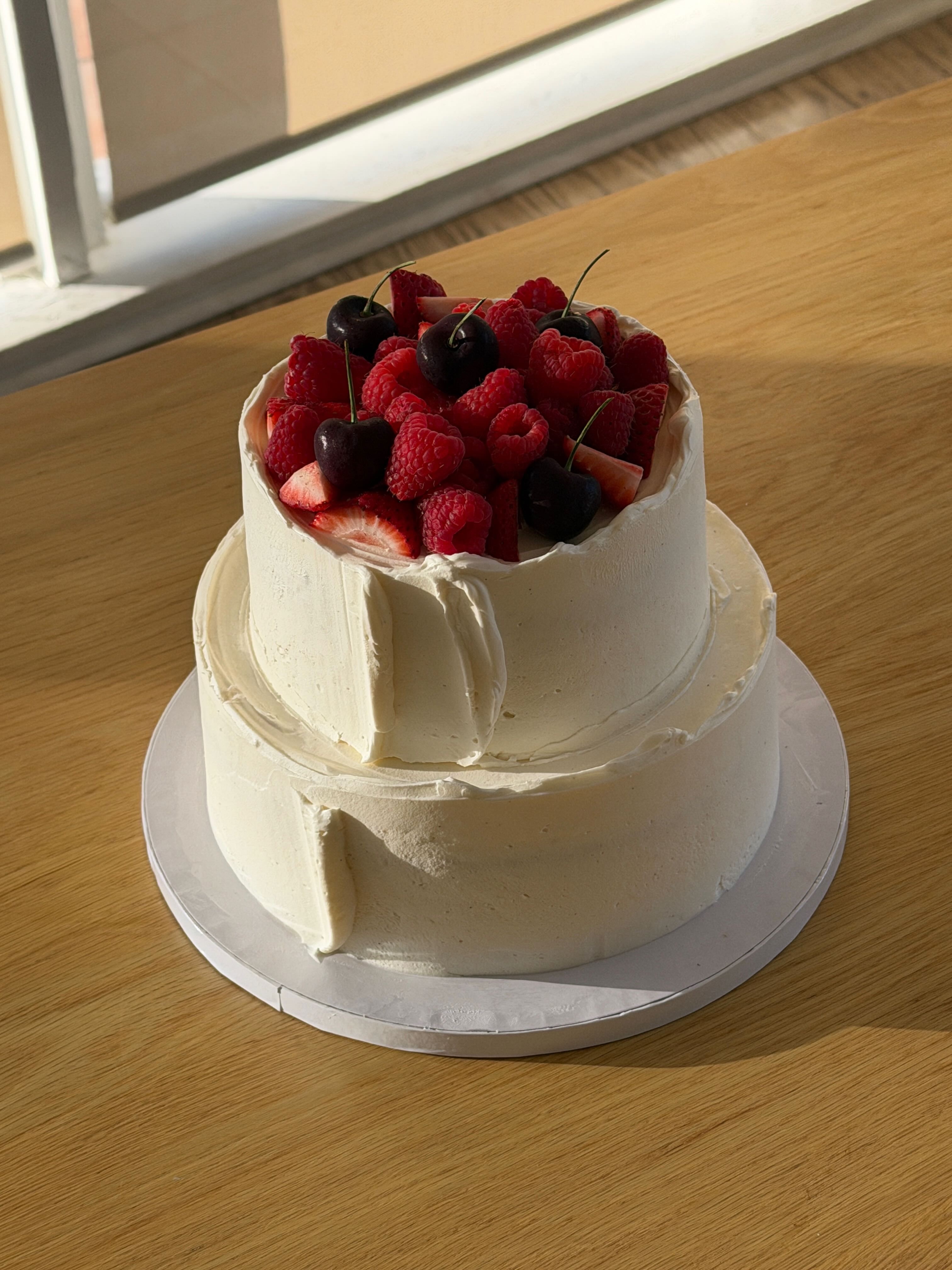 Freshly baked Margherita pizza with melted cheese, tomato sauce, and basil leaves, held by a person’s hand.