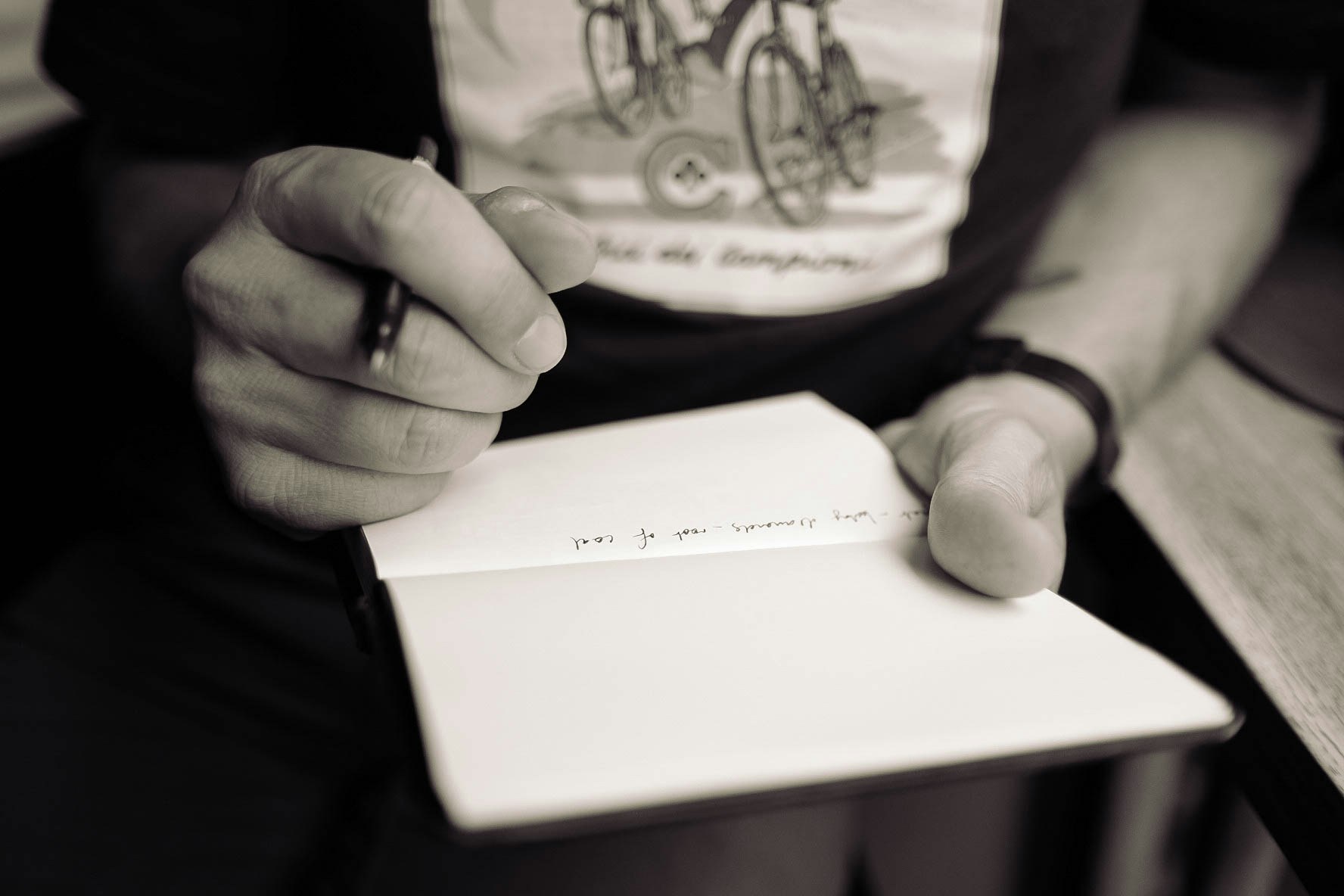 man writing lyrics - How To Make Hip Hop Music