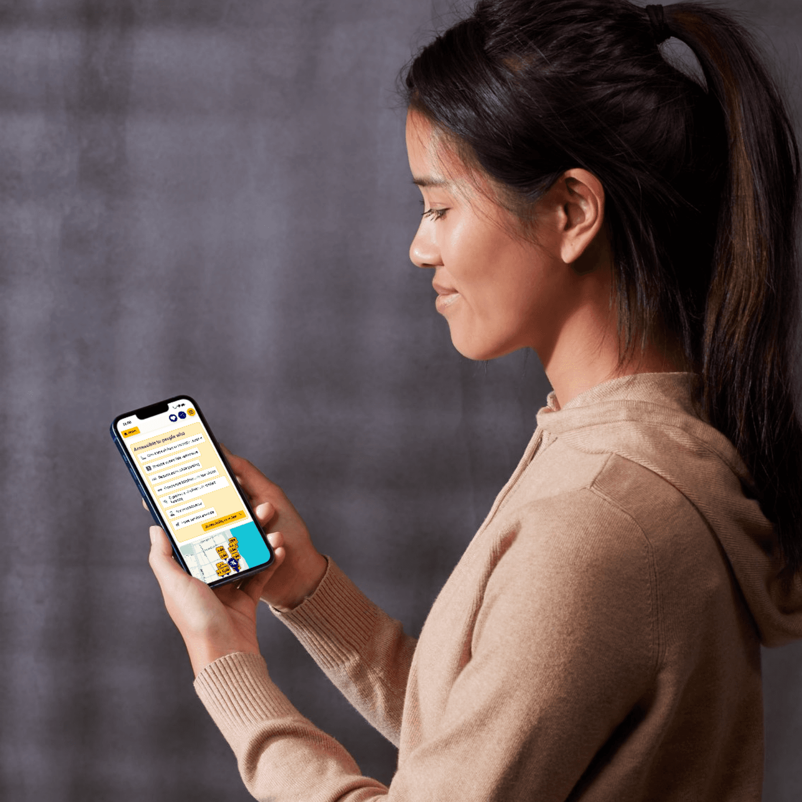 A young woman holding a smart phone looking at access information