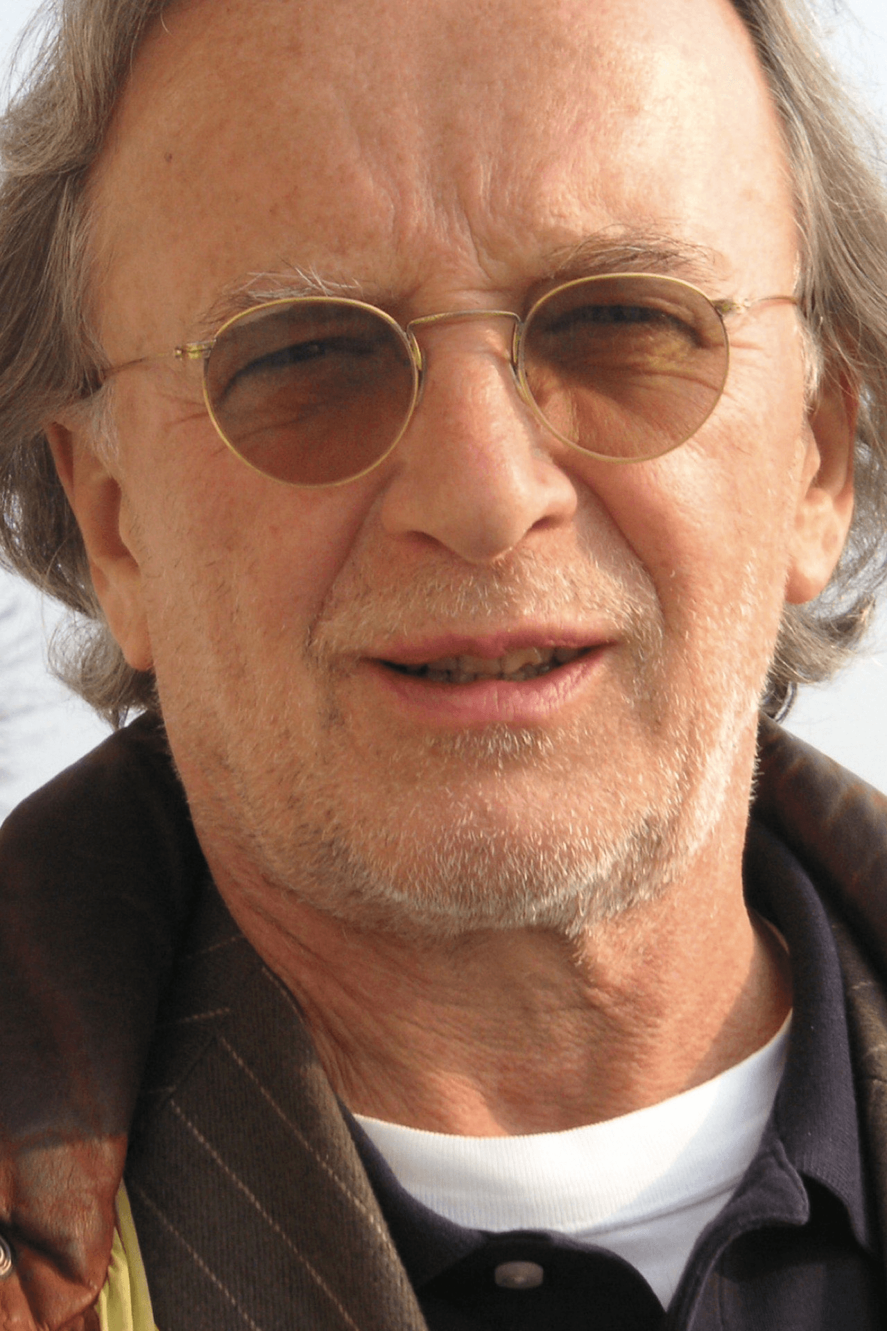 smiling woman wearing blue necklace