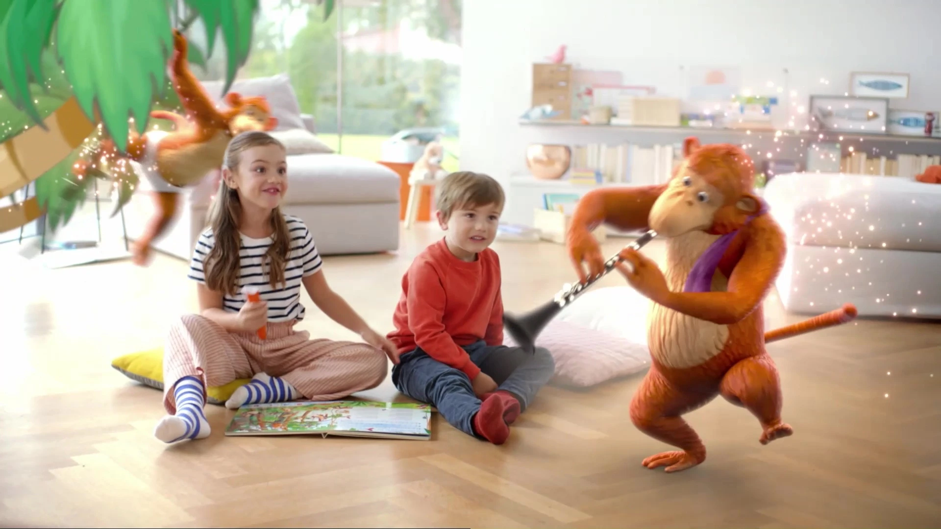 Two kids sitting on the floor in a living room, while two animated monkeys play music for them