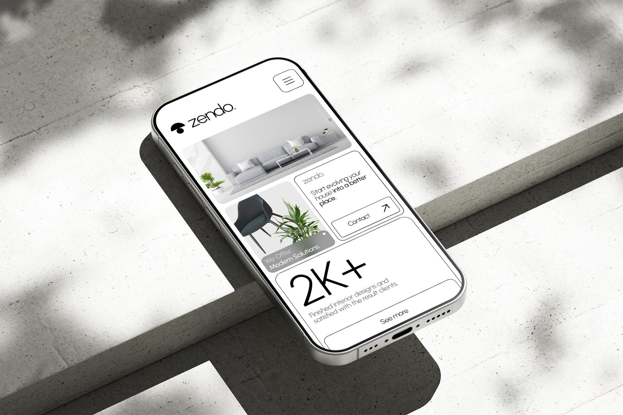 Phone on concrete, website on screen