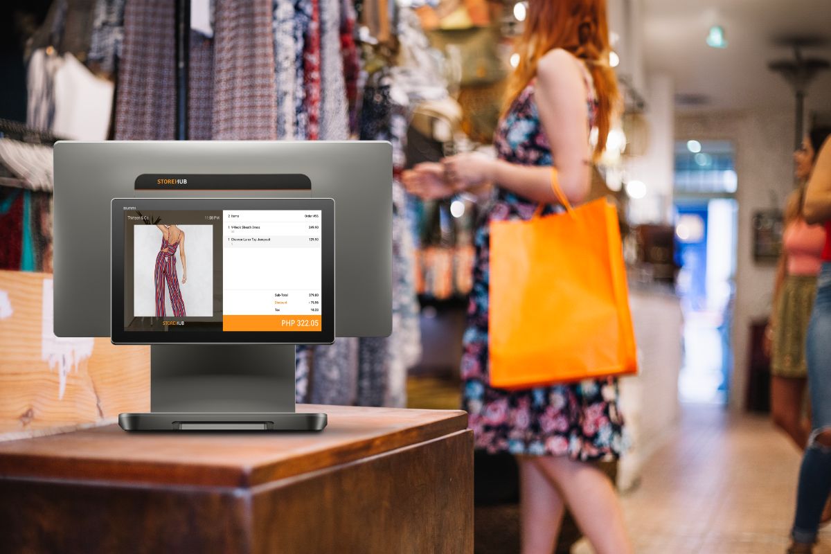Retail store using a POS system while a customer shops in the background