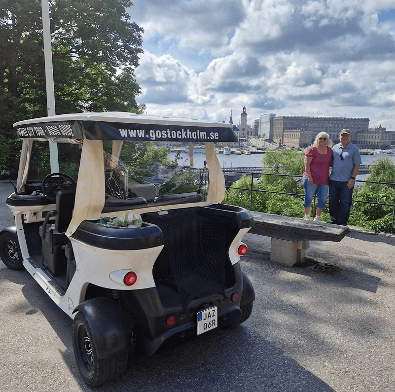 Tourists exploring Stockholm during private electric sightseeing cart tour