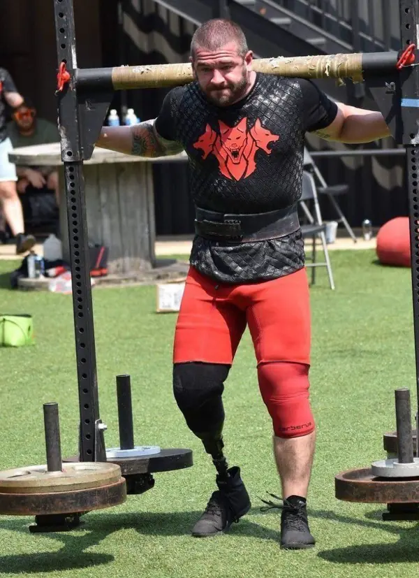 Stephen Moore, strongman competitor and trainer at Big Tex Gym, squatting with a log bar in competition