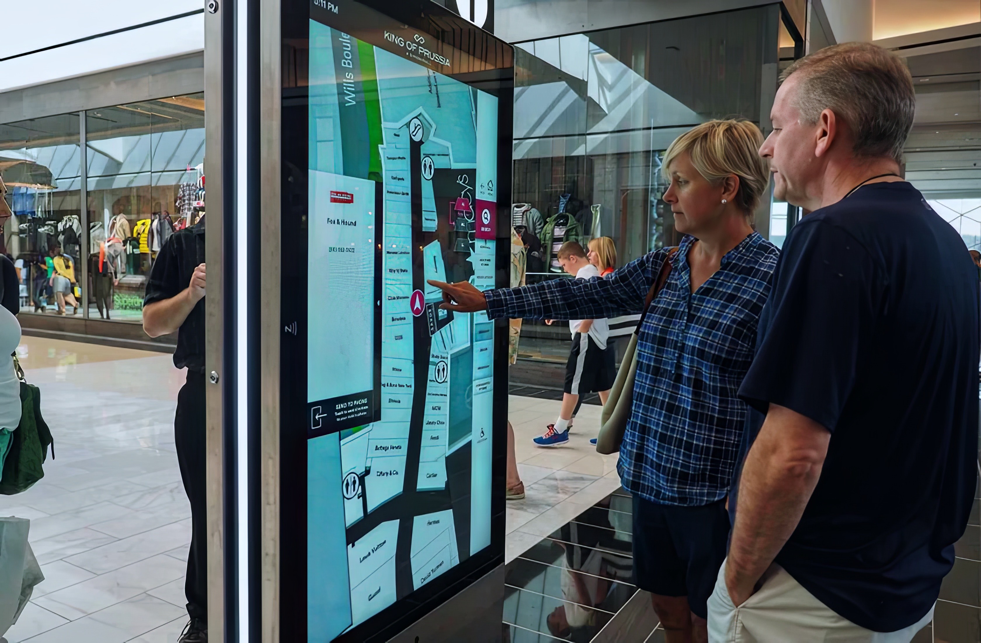 A couple using a touchscreen wayfinder