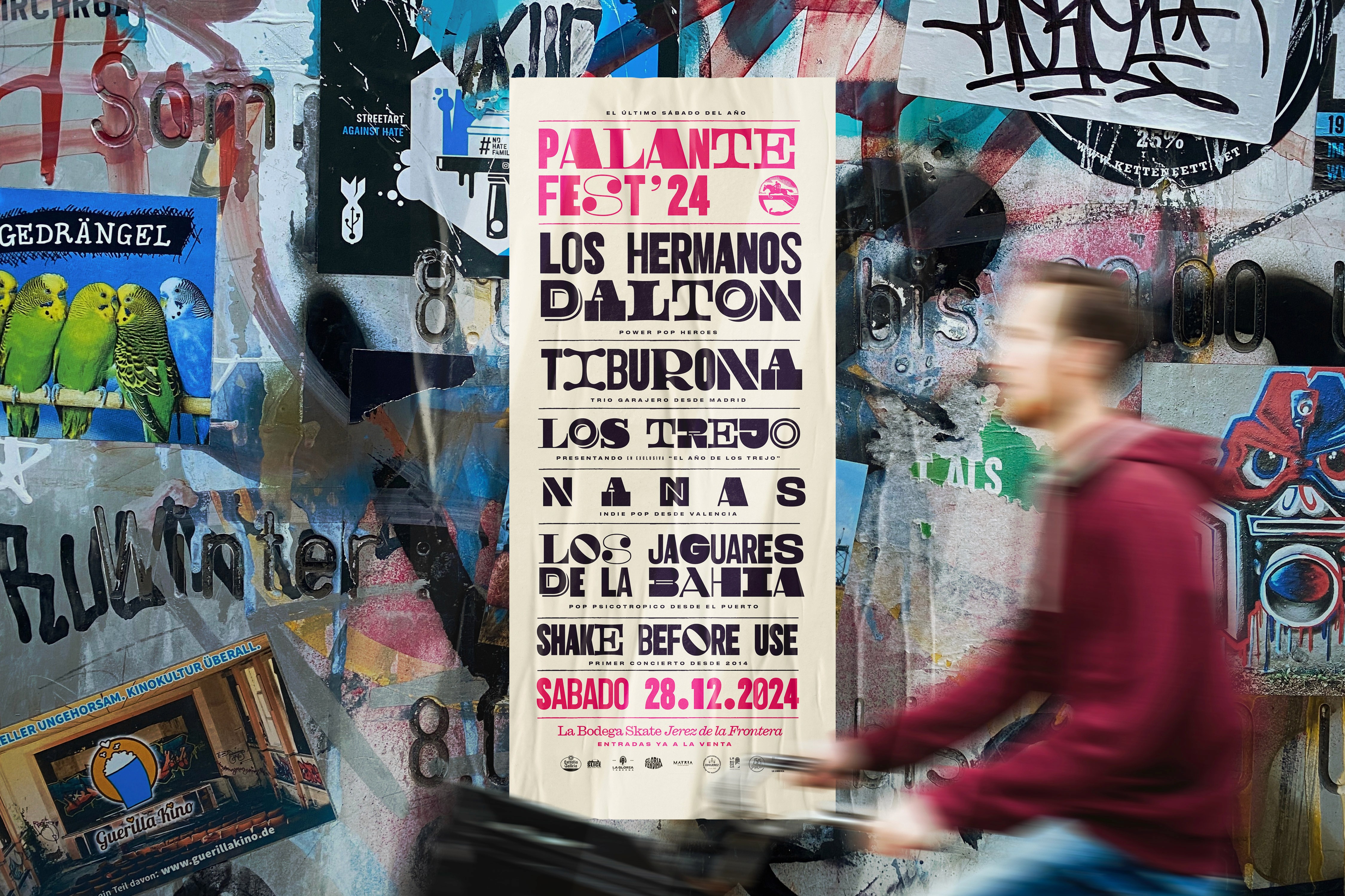 Rock band guitarist jumps high on stage with flaming red guitar during concert.