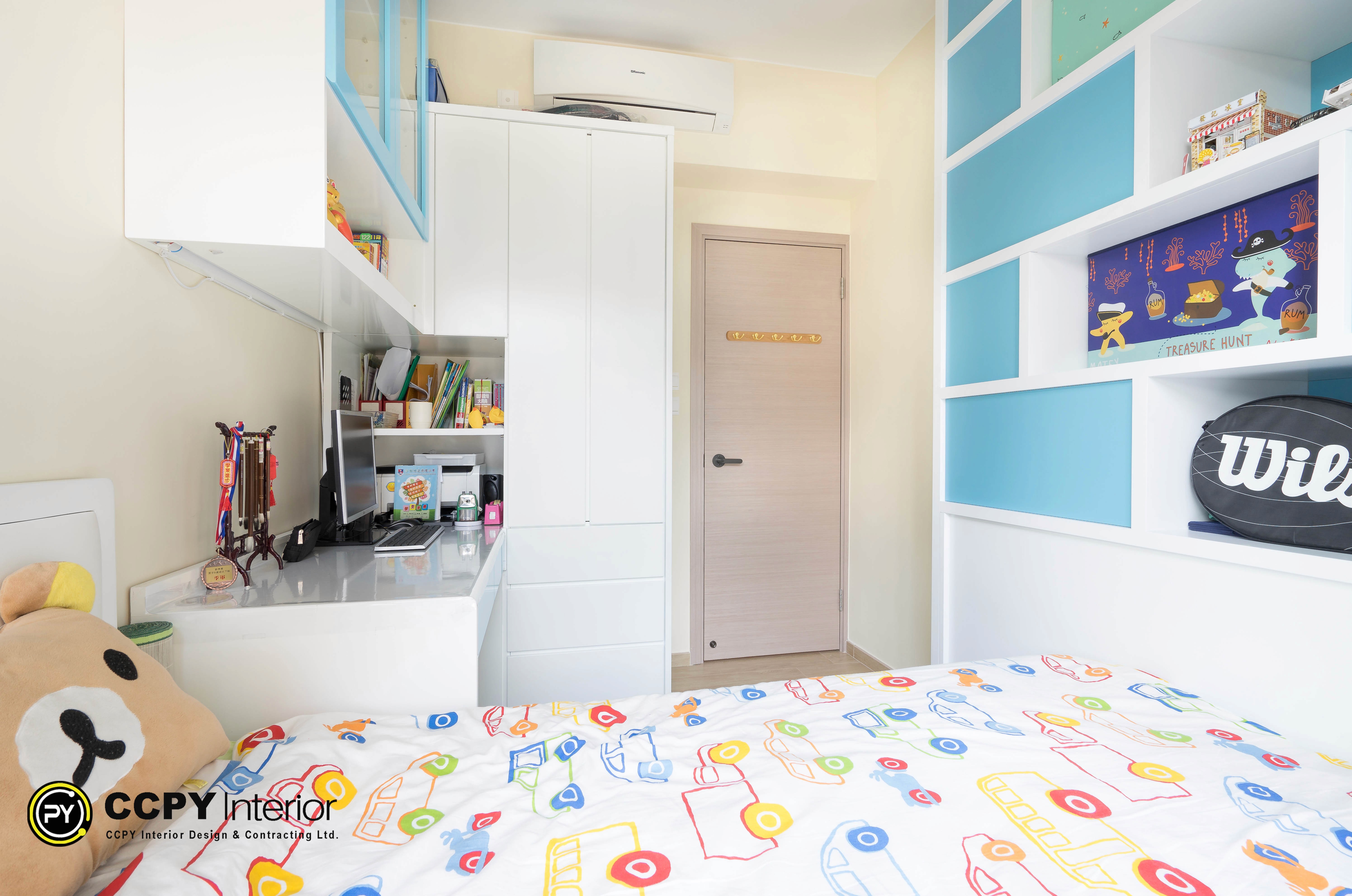 Custom white cabinetry and colorful storage boxes optimize vertical space in a Castello Block3 bedroom.