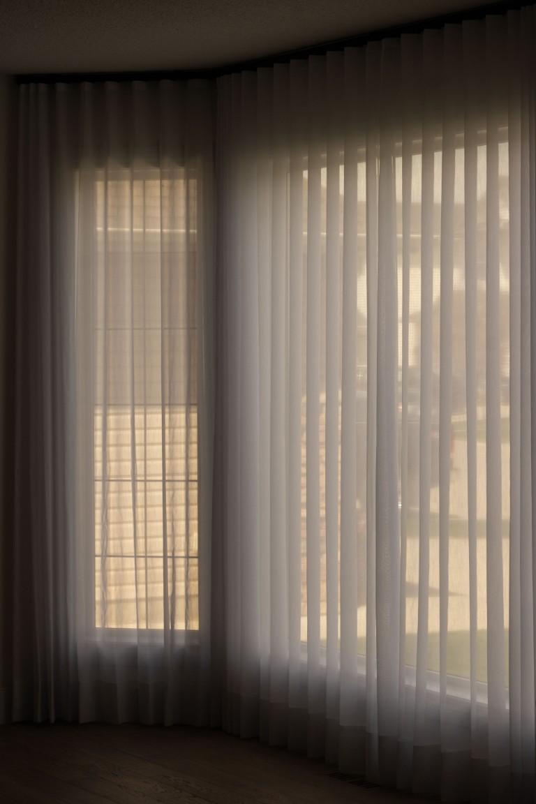 Image of Sheer curtains filter natural light in a room with interior design elements, KHD Homes construction expertise.