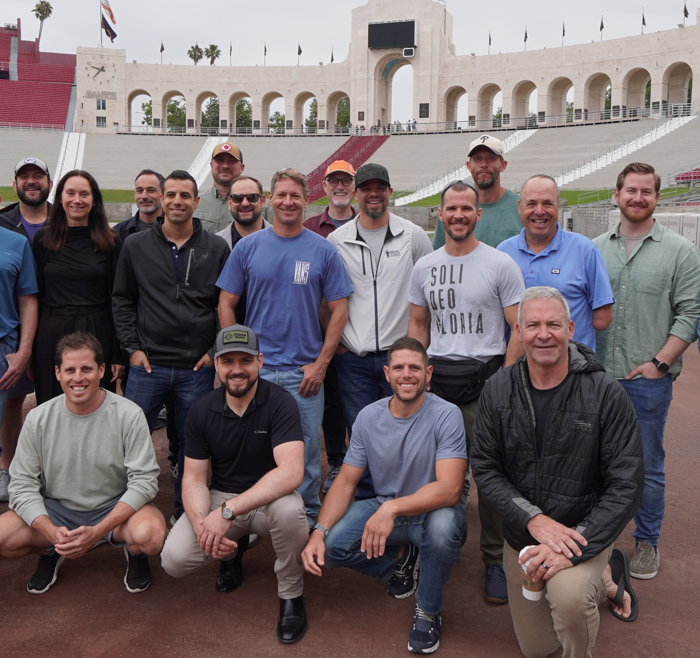 men in black and brown camouflage uniform standing on brown floor