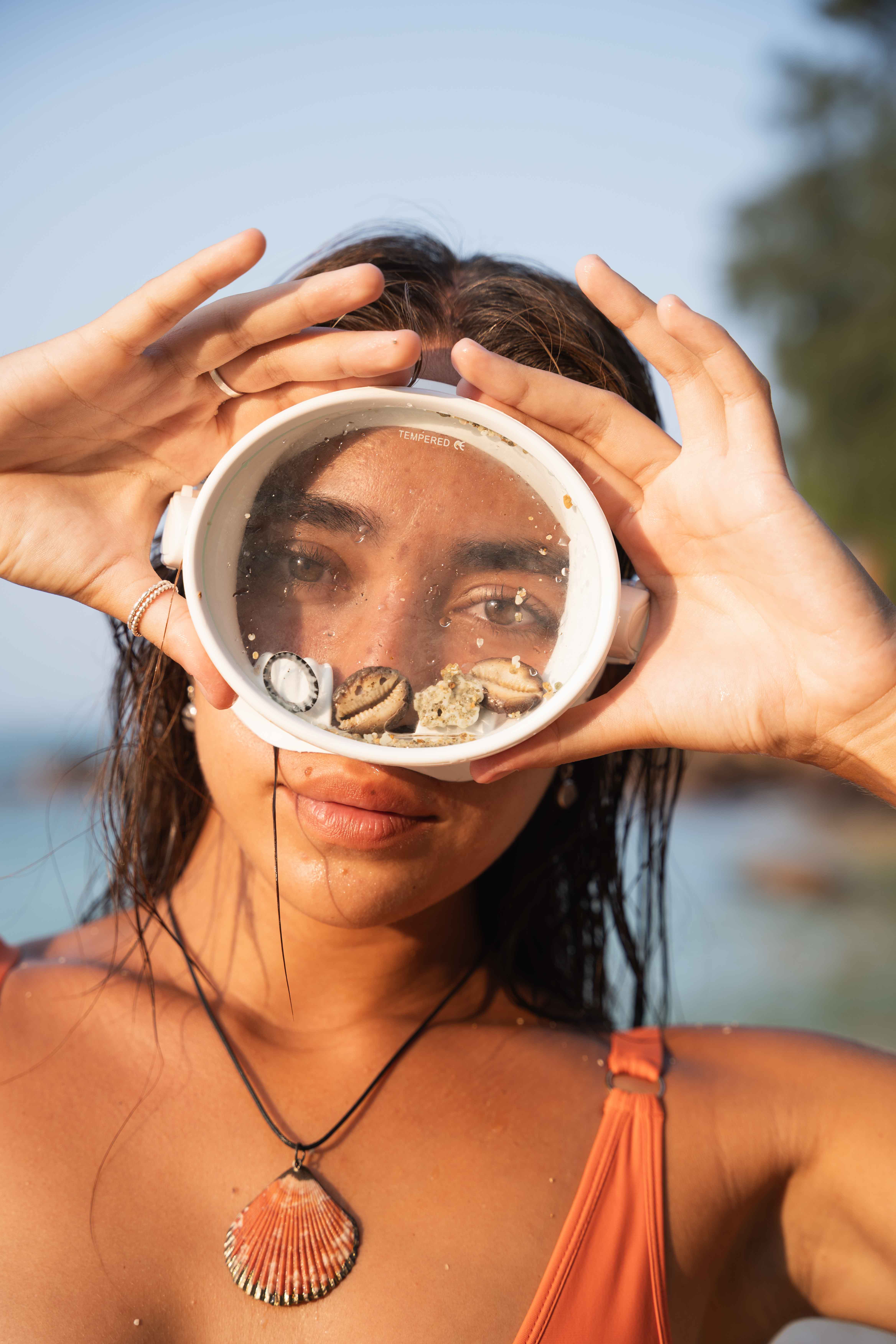 Girl wearing white goggles looking straight into the camera