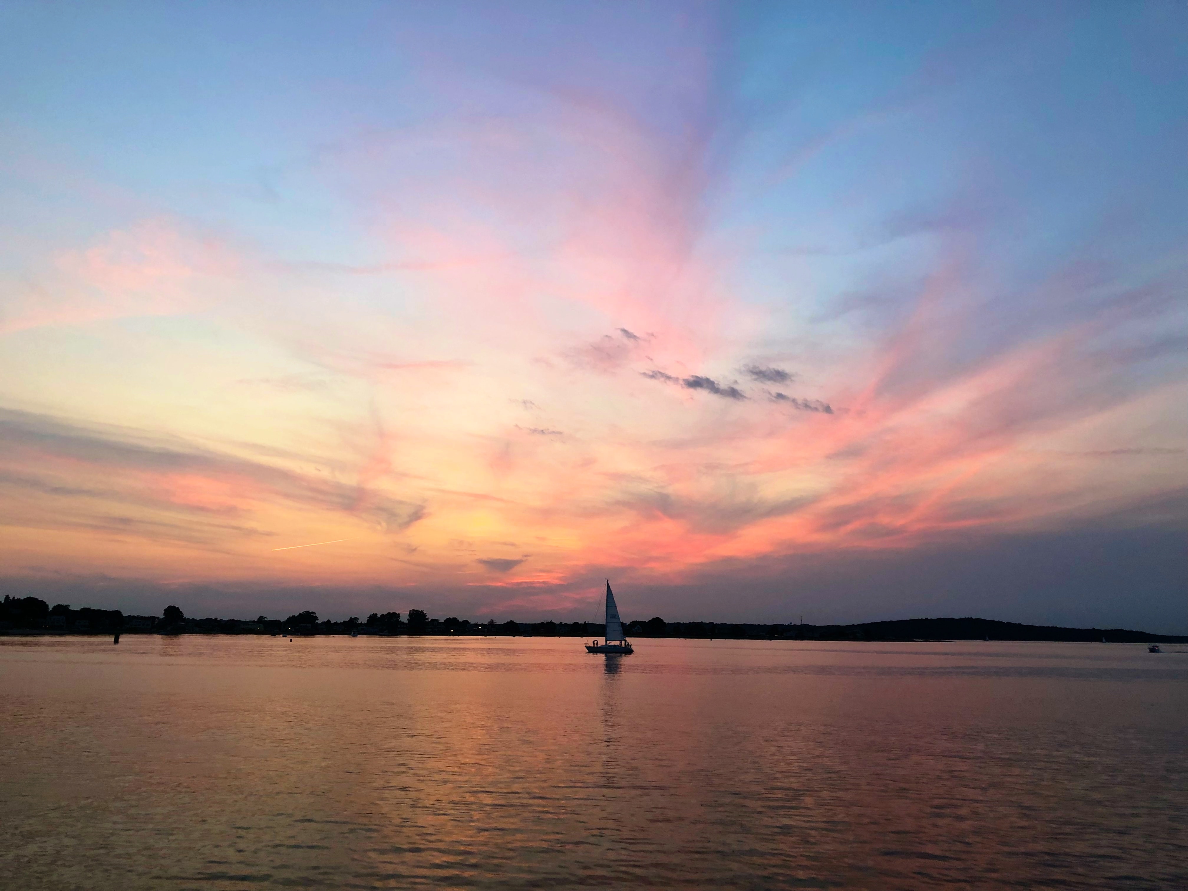 Sailing on a sailboat at sunset, Rhode Island, USA