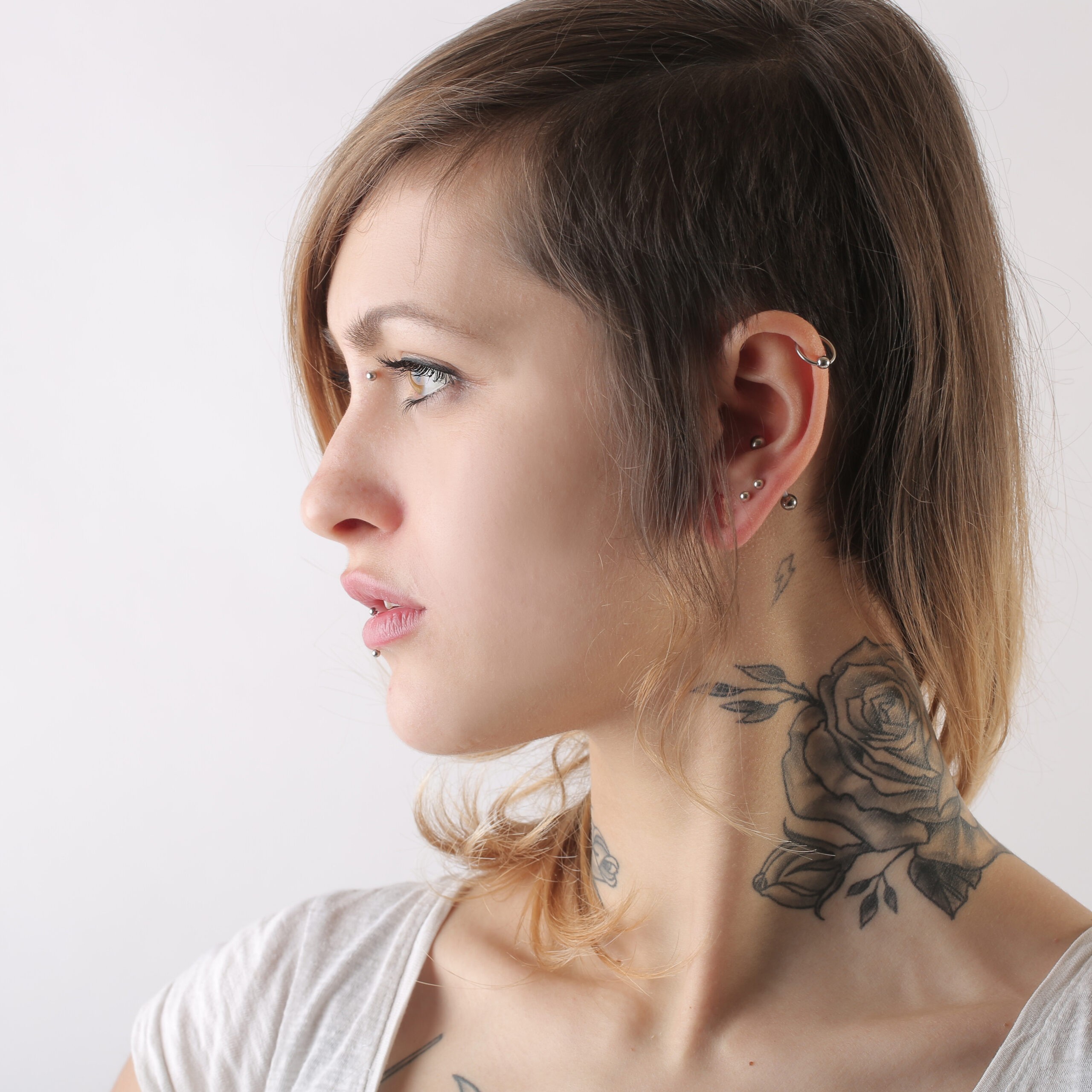 Woman with piercings done by Dermagraphics Skin Studio