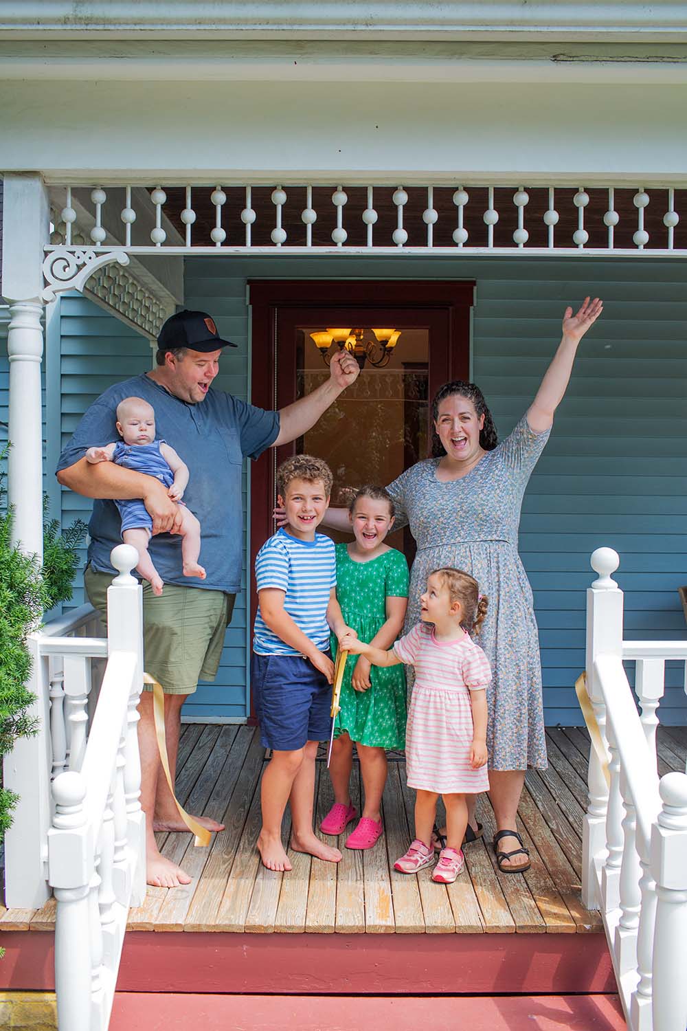 family on front porch of their home