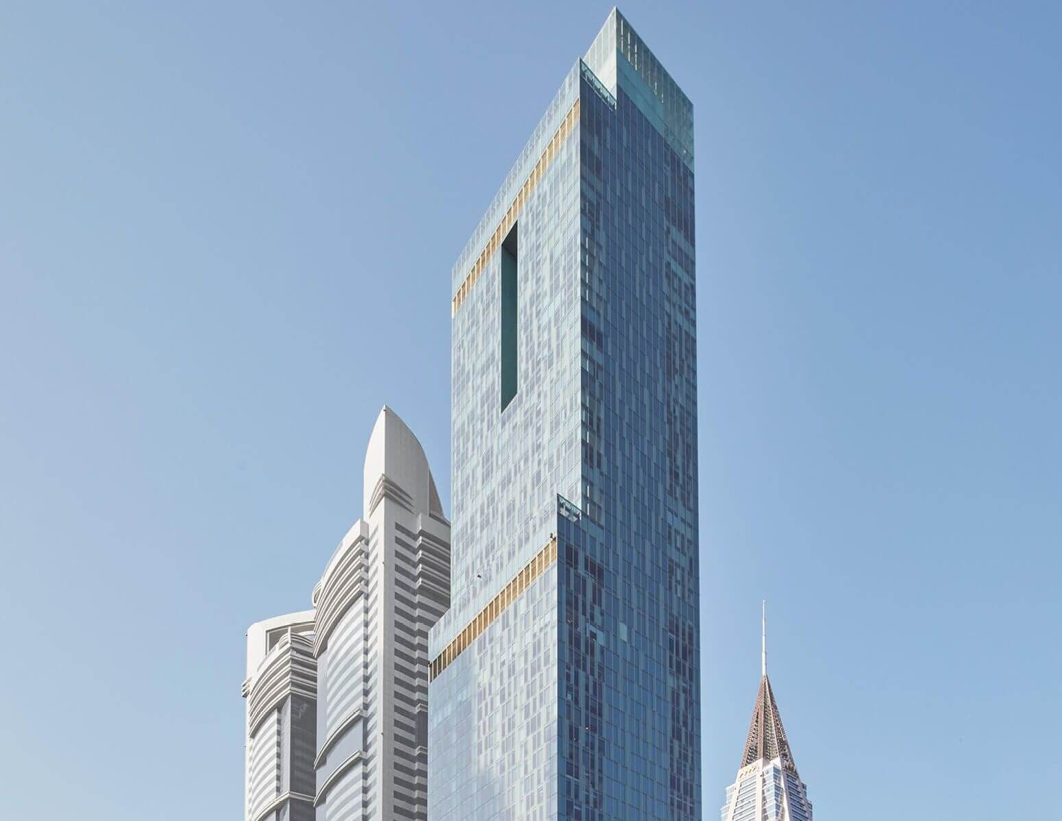 Sky-high view of the iconic glass facade of Rolex Tower, representing luxury property in the heart of the city.