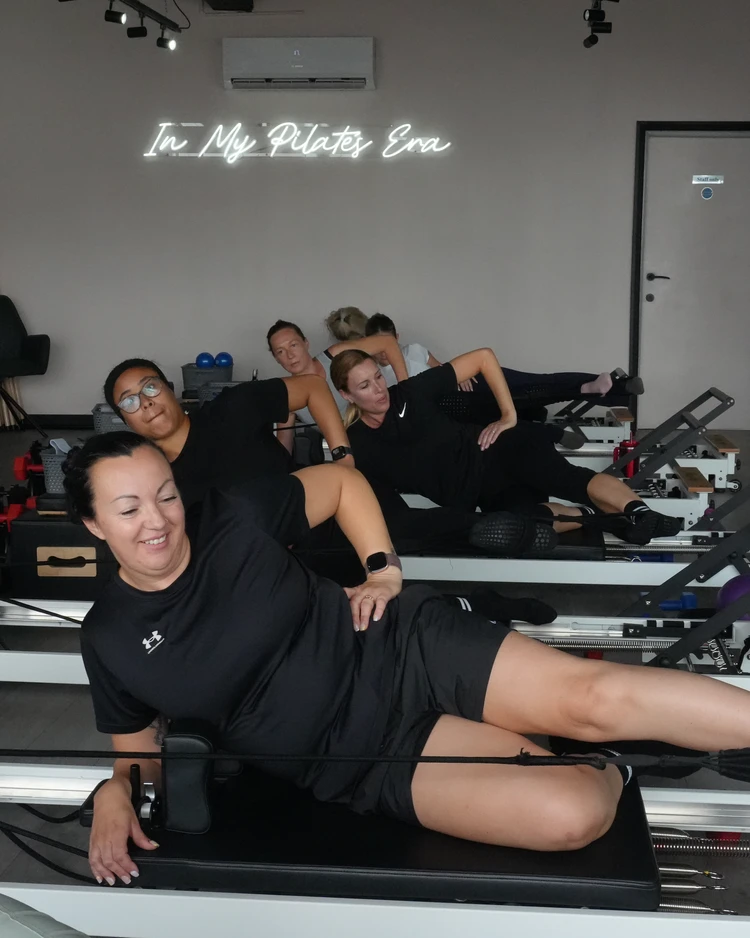 Mixed ability Reformer Pilates class at Studio Switch in Leigh-on-Sea with members performing guided core strengthening exercises.