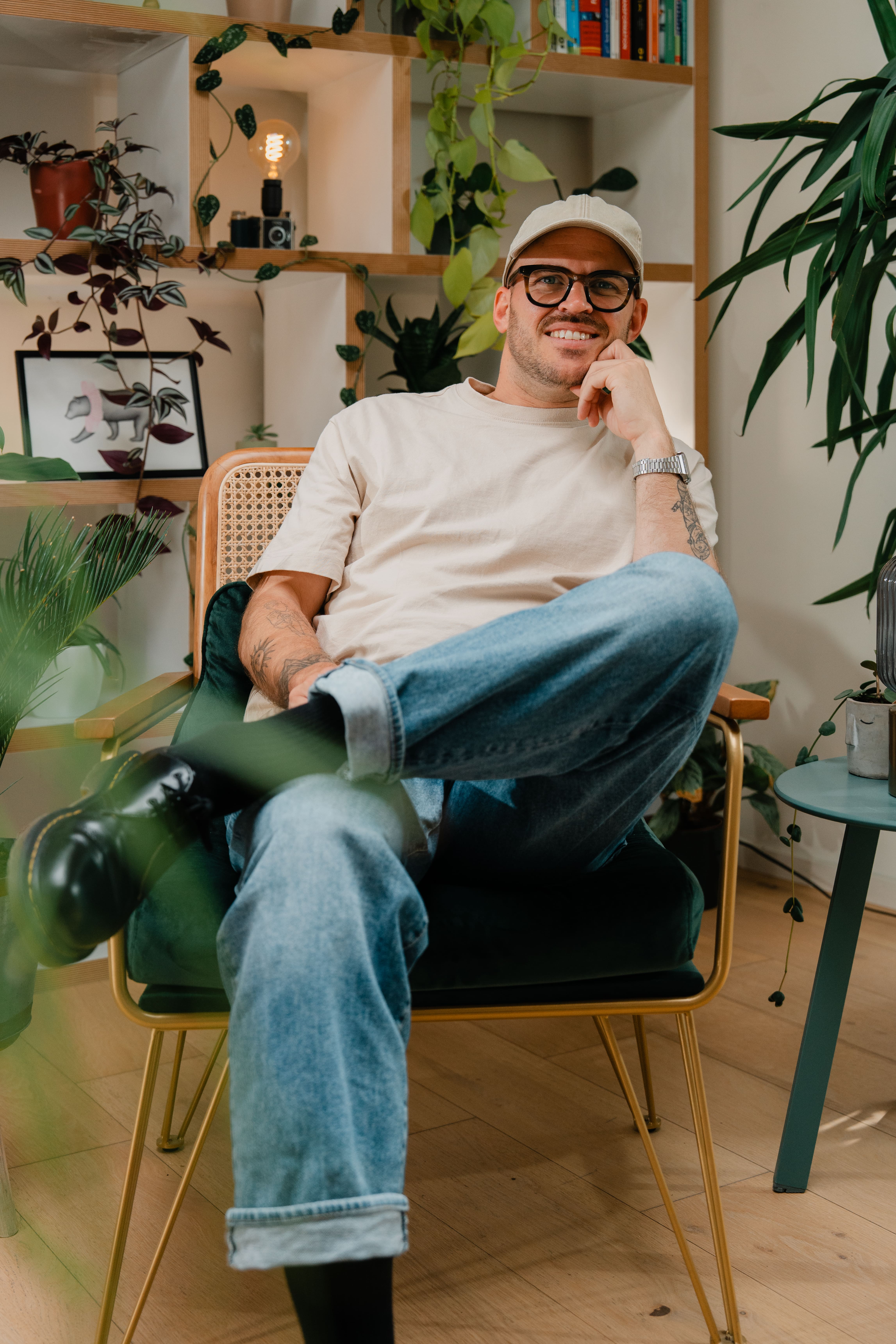Monochrome product shot: black-capped cosmetic bottle with dynamic water splash on a clean white background.