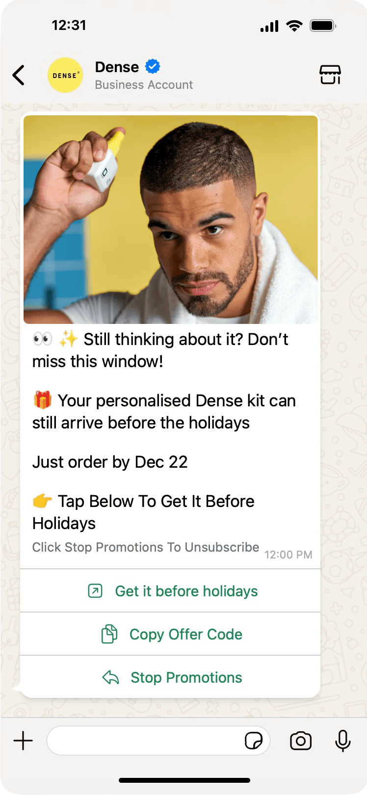 Man and woman standing together at a desk with a laptop and notebooks, smiling at the camera.