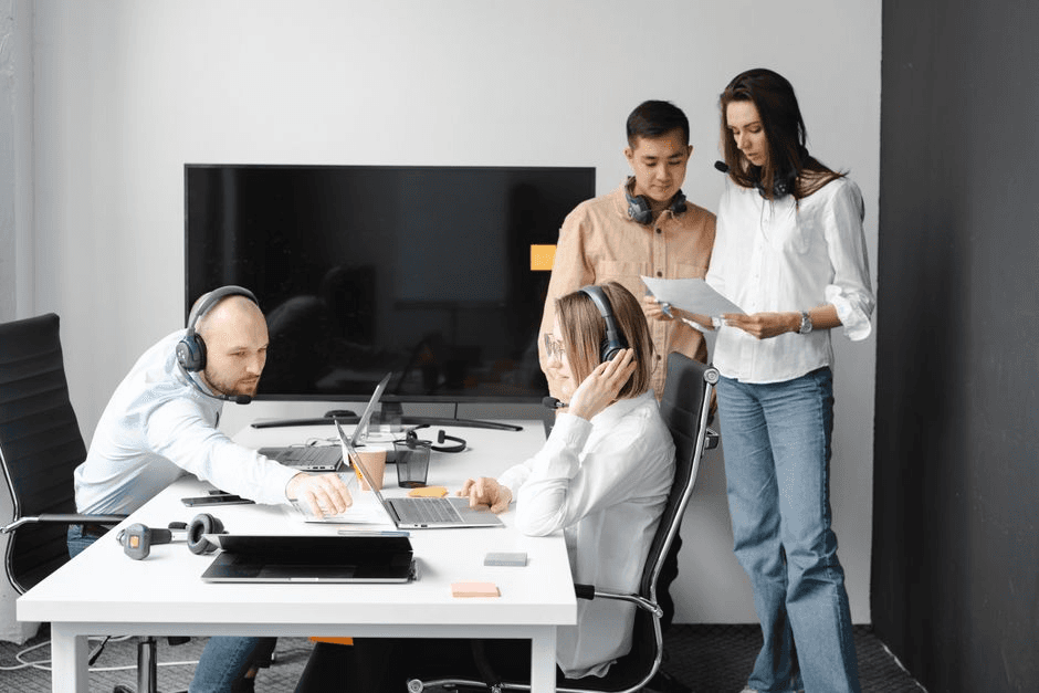 Revenue operations or sales team looking at a CRM pipeline dashboard on screen.