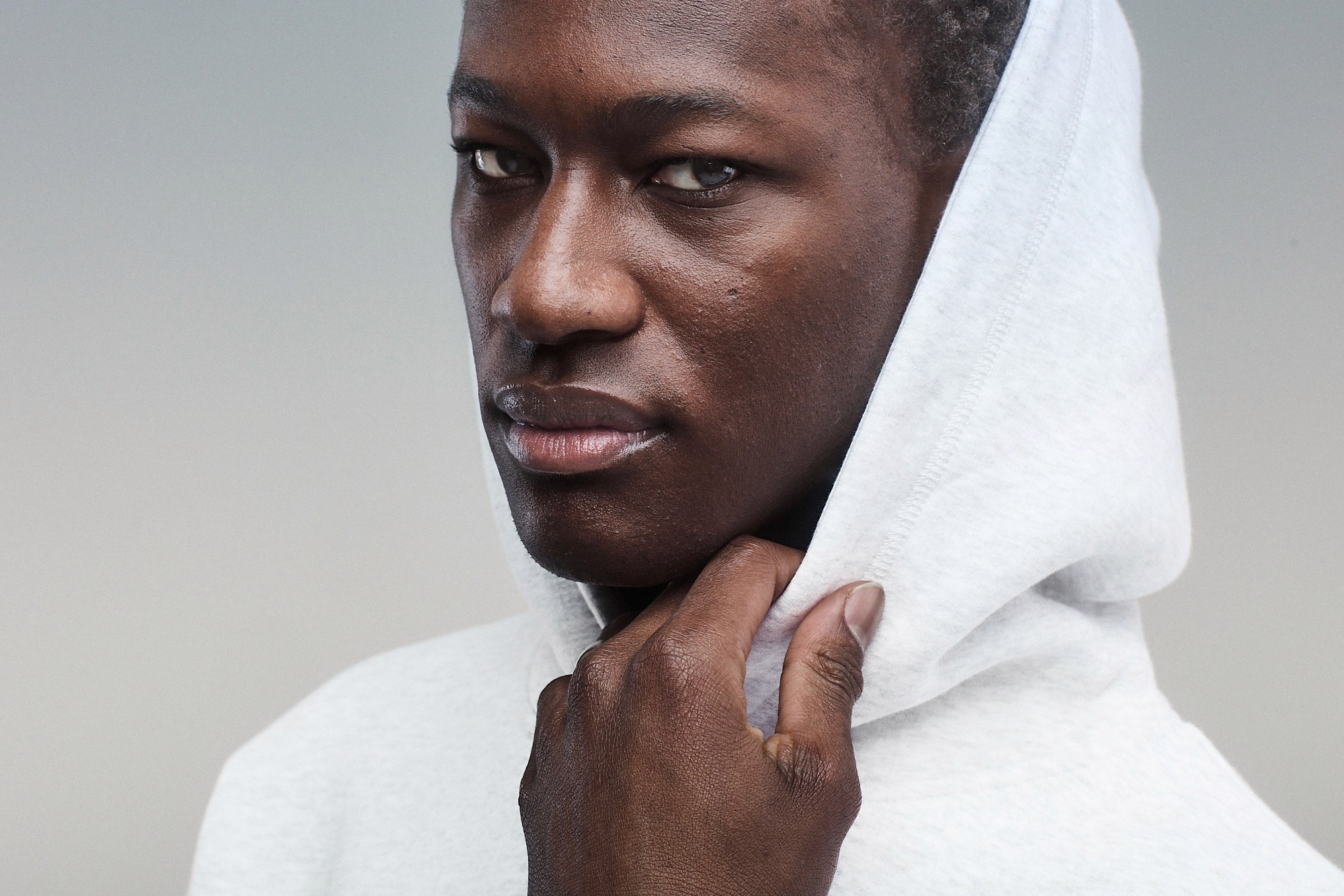 Two women by the water wearing navy and light grey hoodies with matching lounge shorts, relaxed casual summer outfits.
