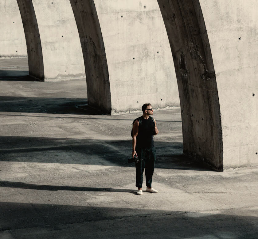 Advisor walking beneath architectural shadows