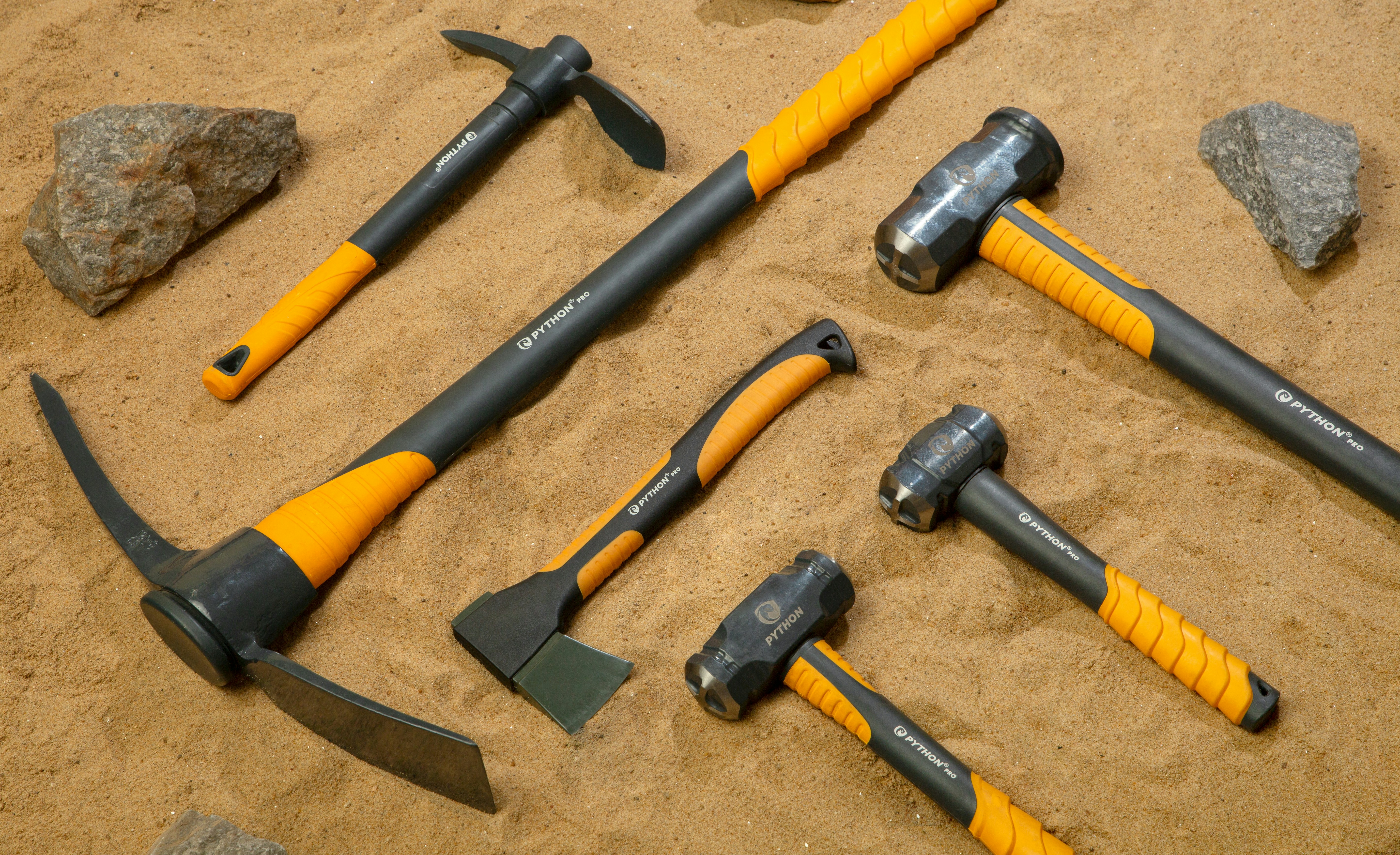 A bunch of tools are laying out on the sand