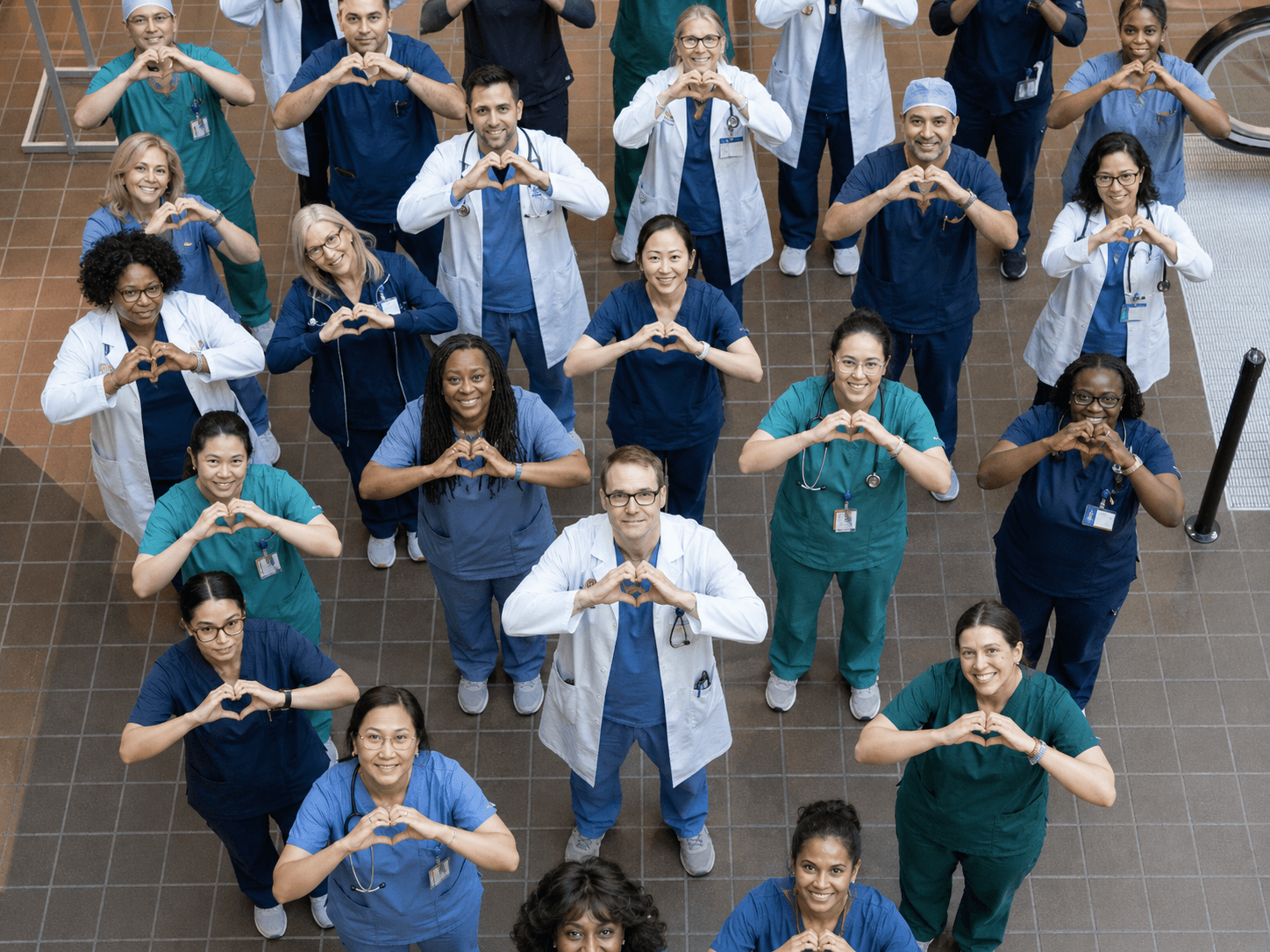 Group of people forming a heart shape with hands