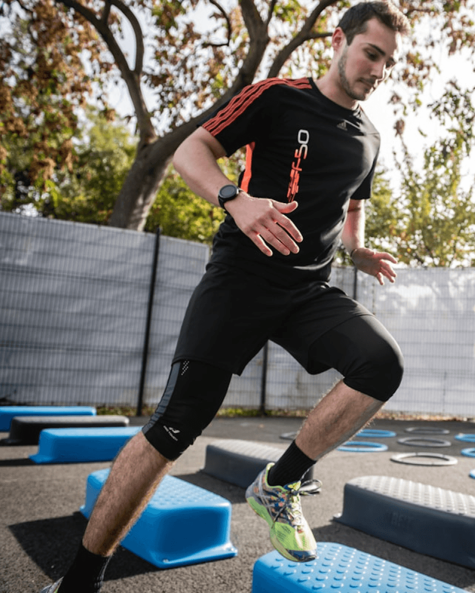 man in workout clothes doing horizontal step workout