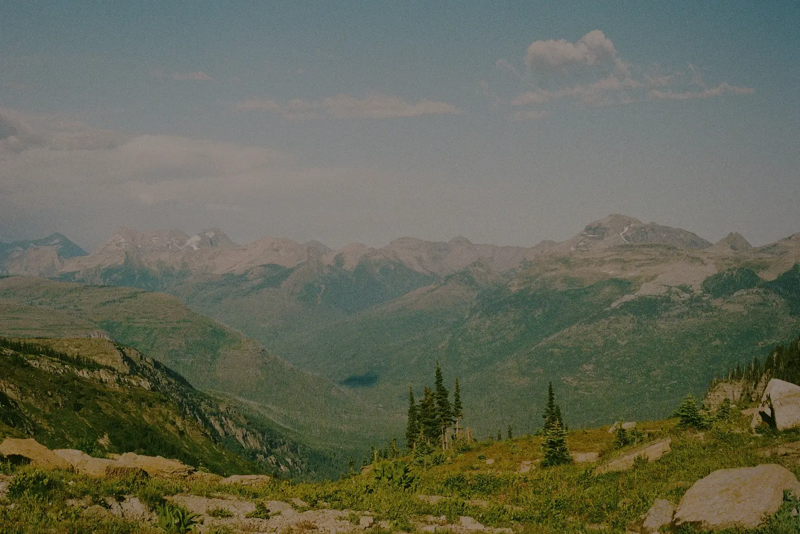 A landscape image on the mountains with a tent near a lake