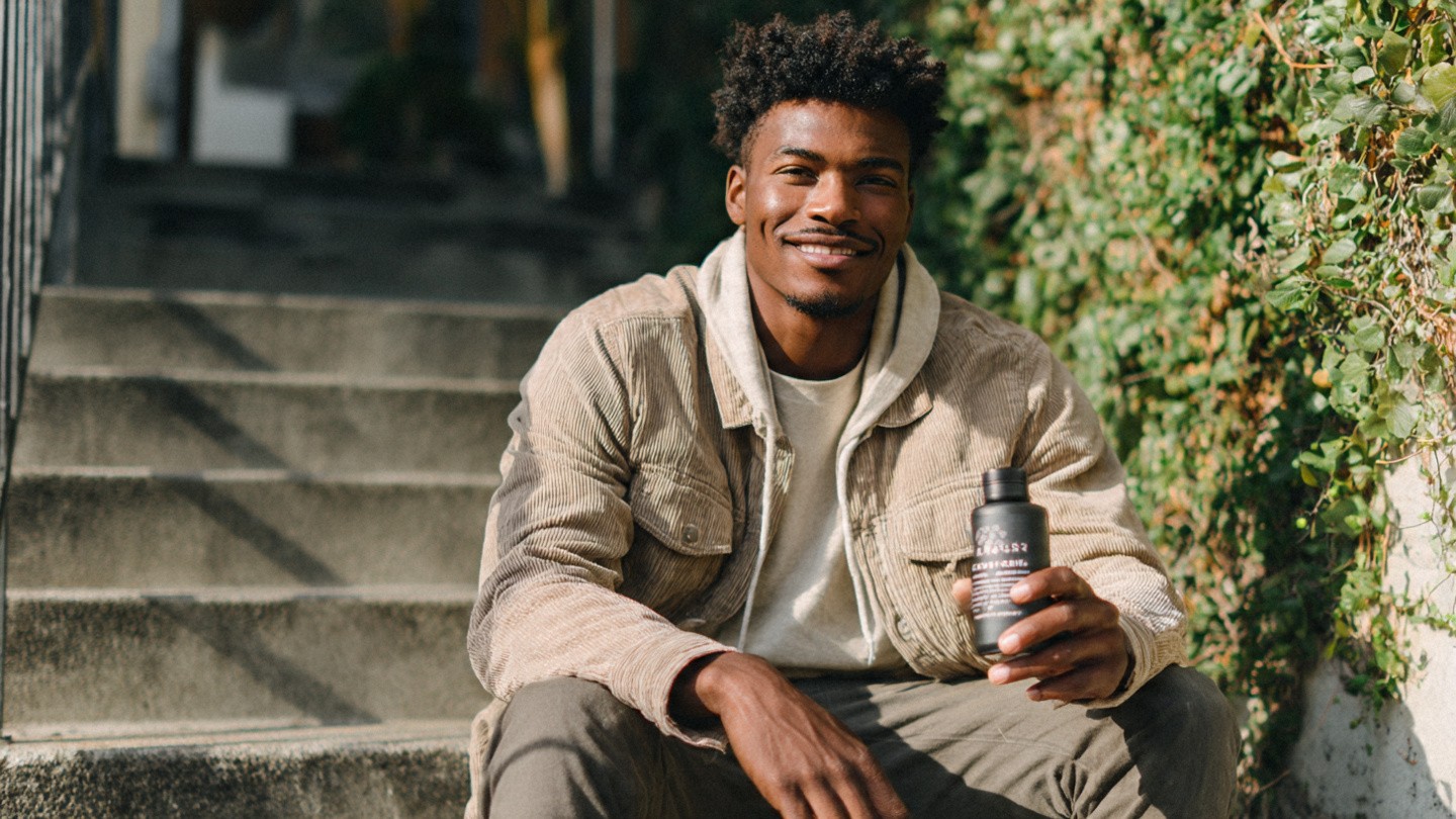 young_man_sitting_on_balcony_steps_in