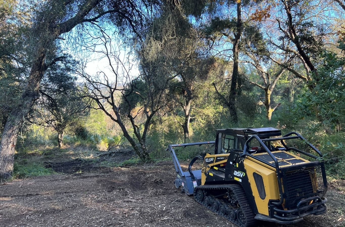 Lisac General Engineering team clearing overgrown land in Santa Clara, CA with advanced machinery for efficient site preparation.