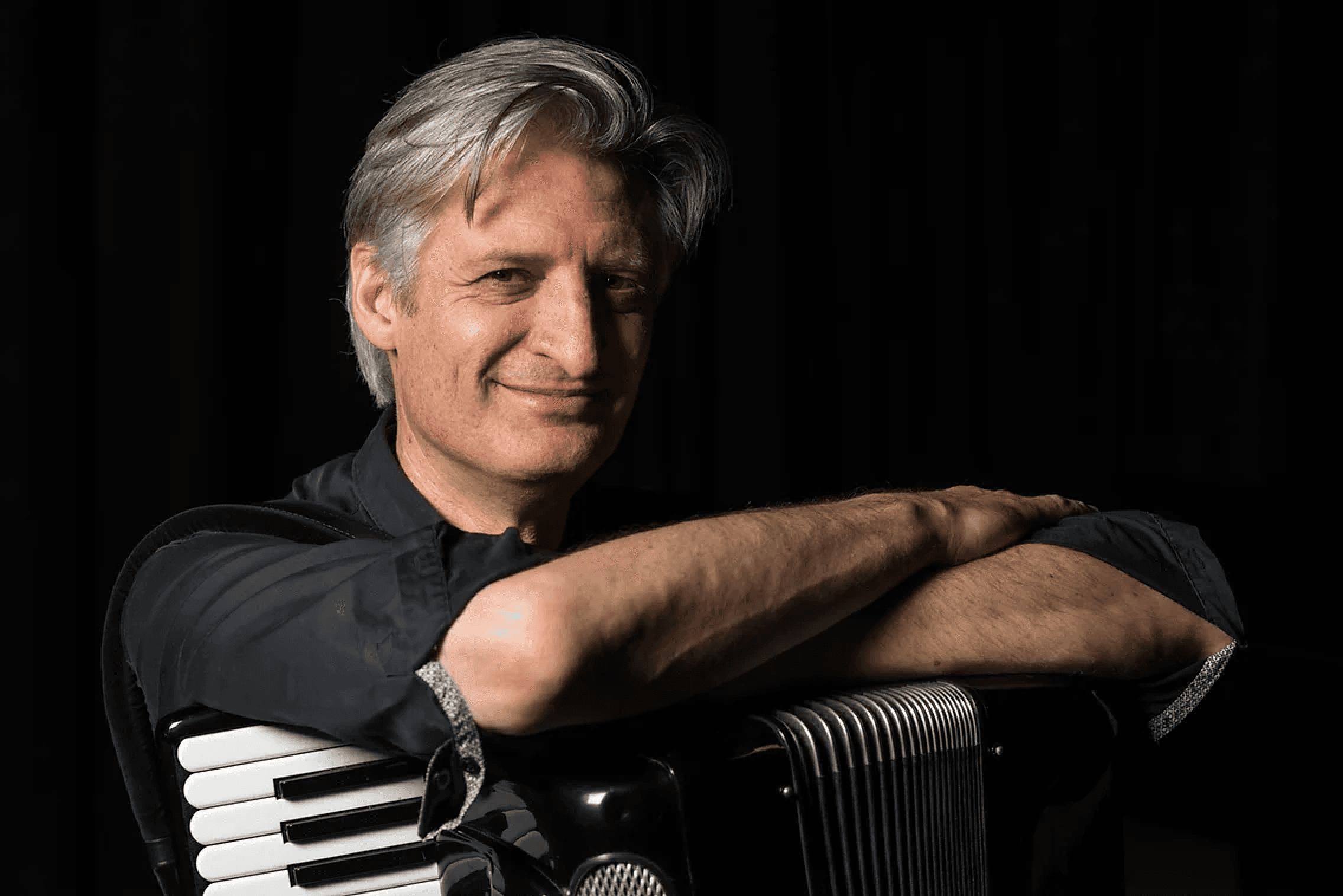 Anthony sitting with his accordion