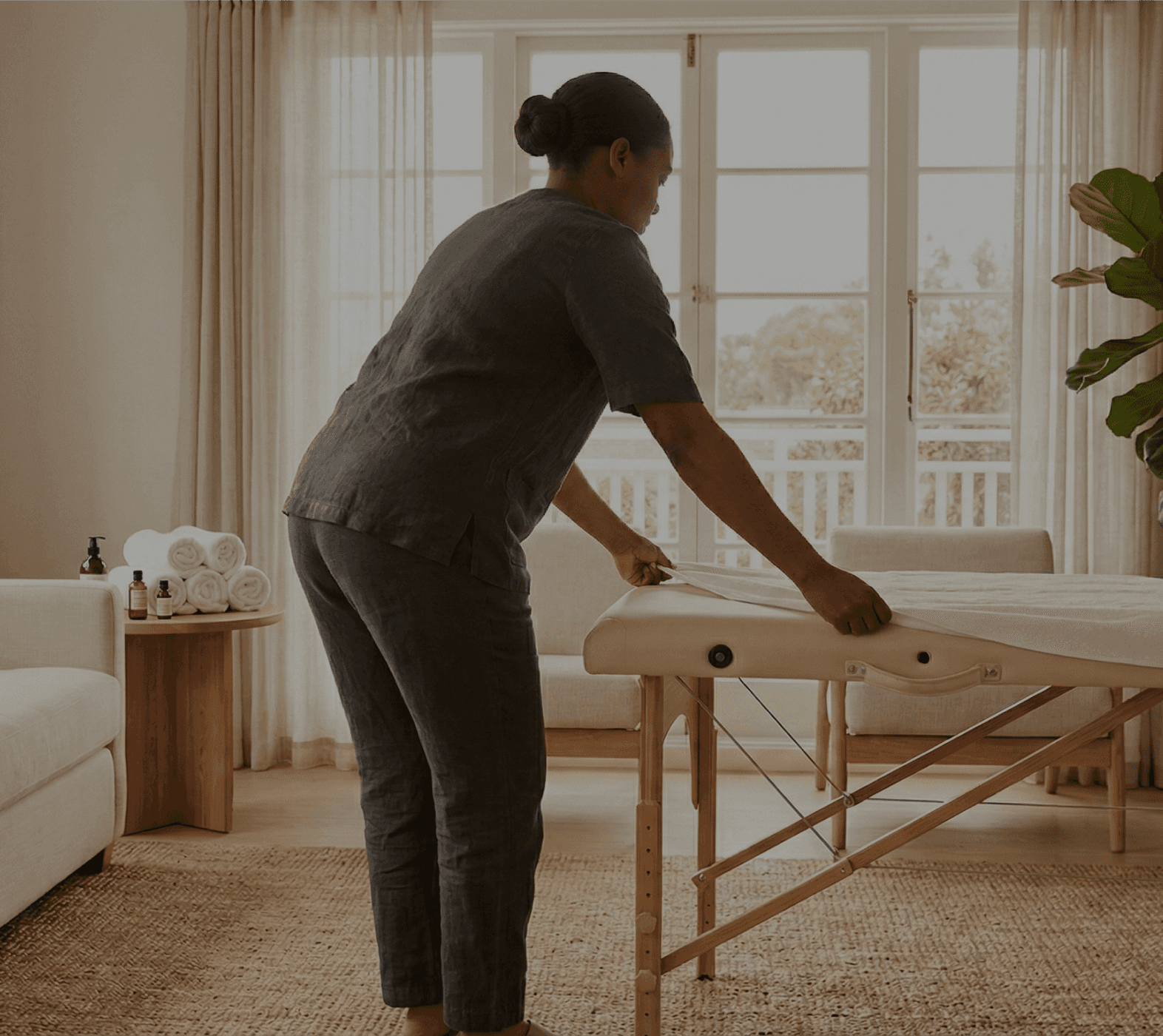 Professional mobile spa therapist setting up an intentional massage sanctuary for an in-residency ritual in Sandton.