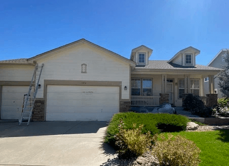 Residential home with the original light exterior finish before painting.