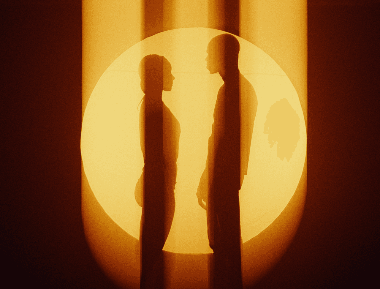 Silhouetted figures against a glowing sun, scene from “Hot Like U” by Sam Austins, post-production by The Machine Shop