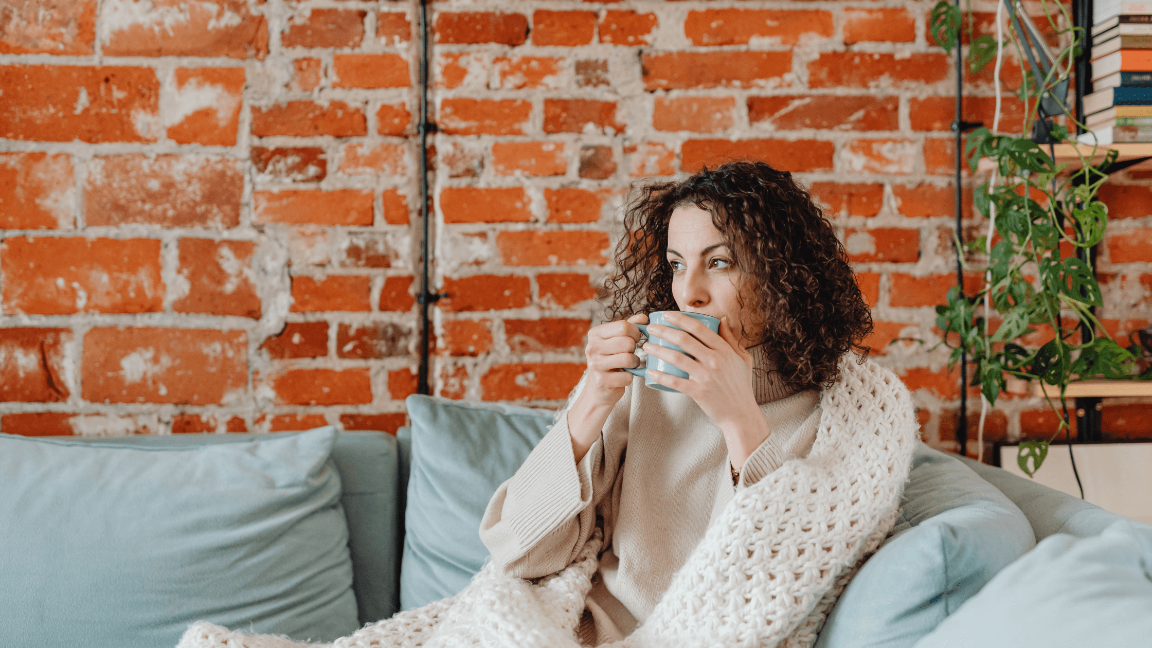 Woman resting comfortably at home wrapped in a blanket during recovery