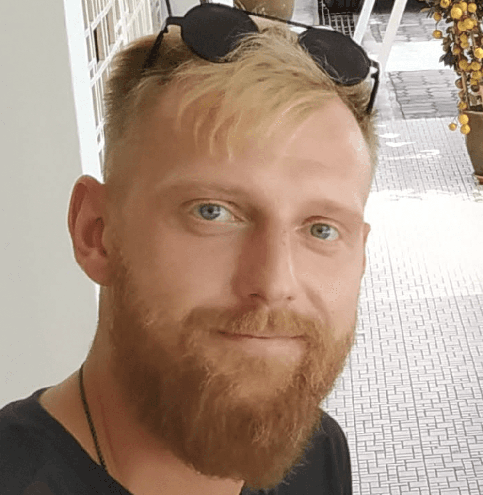 Close-up portrait of a man with gray hair and beard