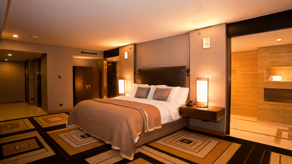 Elegant hotel bedroom with ambient lighting, contemporary furniture, and neutral tones | Lunasole Hospitality