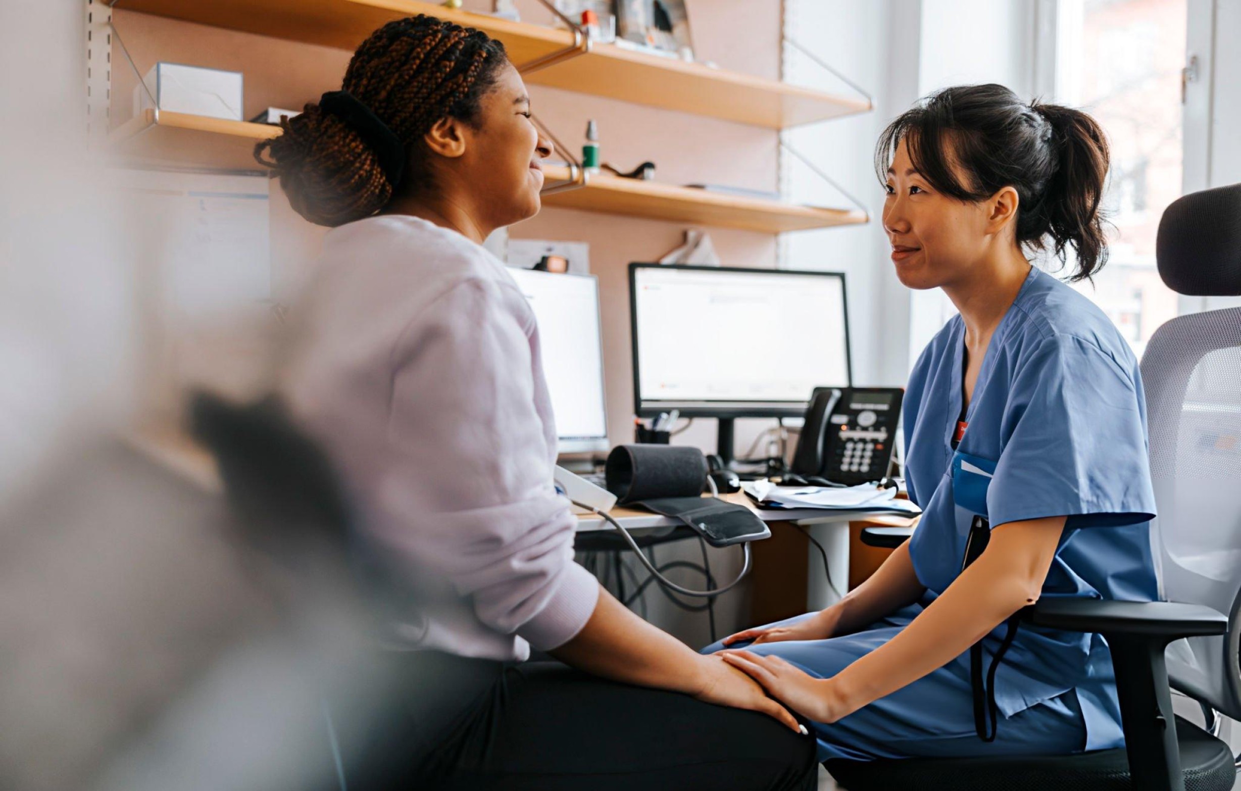 woman holding a phone and man looking at the phone. both are smiling